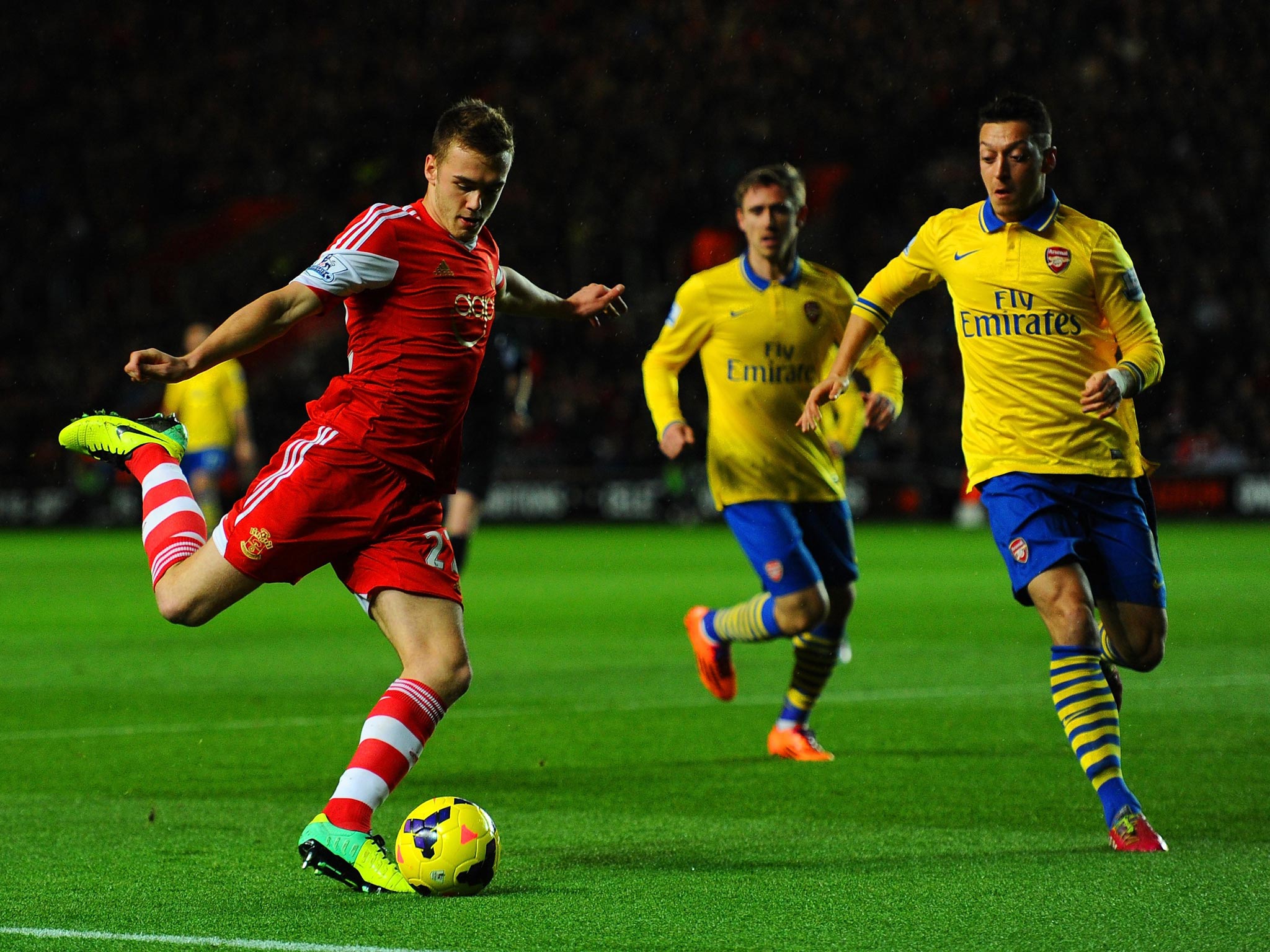 Mesut Oezil of Arsenal keeps a close eye on Calum Chambers of Southampton