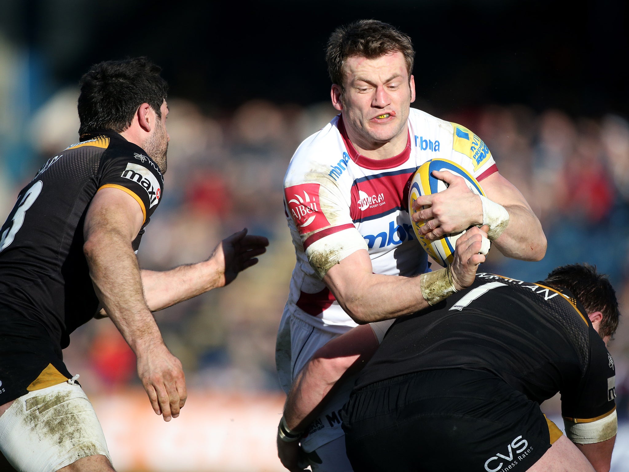 Mark Cueto of the Sale Sharks runs into Wasps prop Matt Mullan