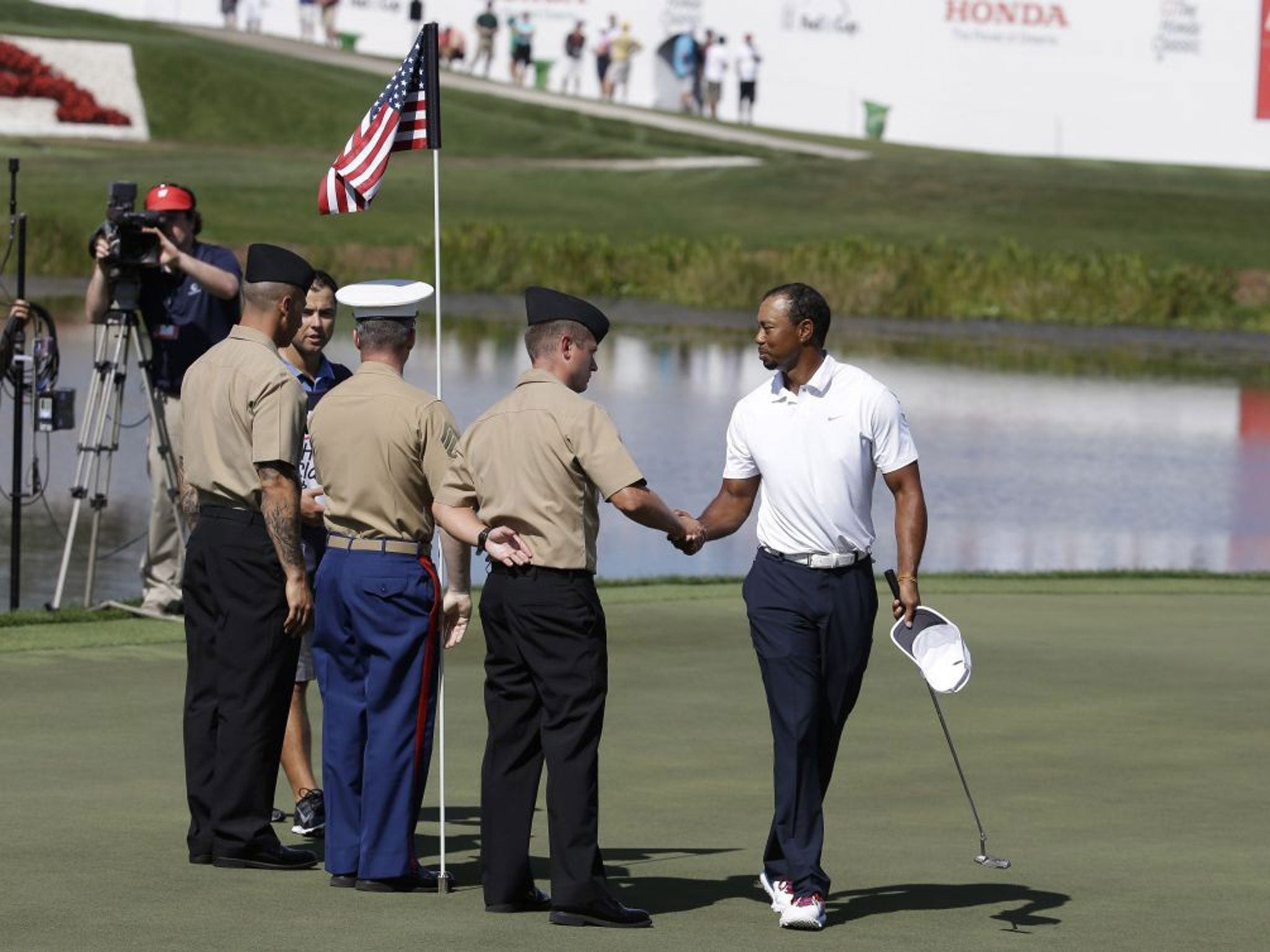 Shake on it: Tiger Woods was happy to hit form after a difficult spell