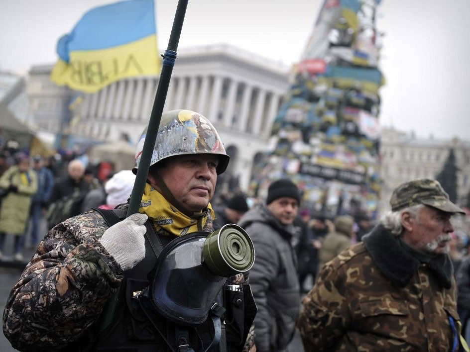 A so-called Maidan self-defence unit member in Independence square in central Kiev, where protesters resumed their public display of defiance today