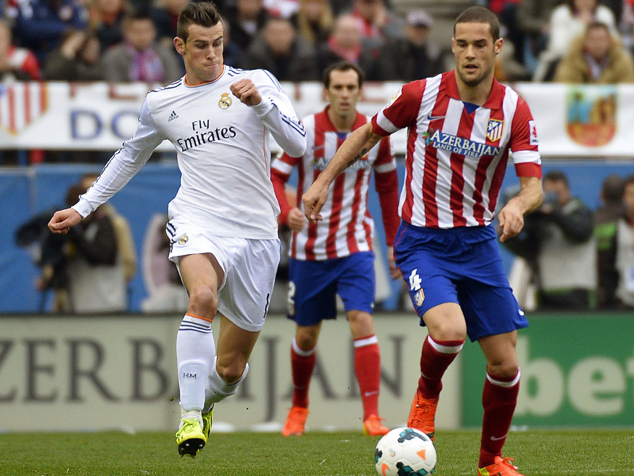 Bale (left) vies for the ball with Mario Suarez (GETTY)