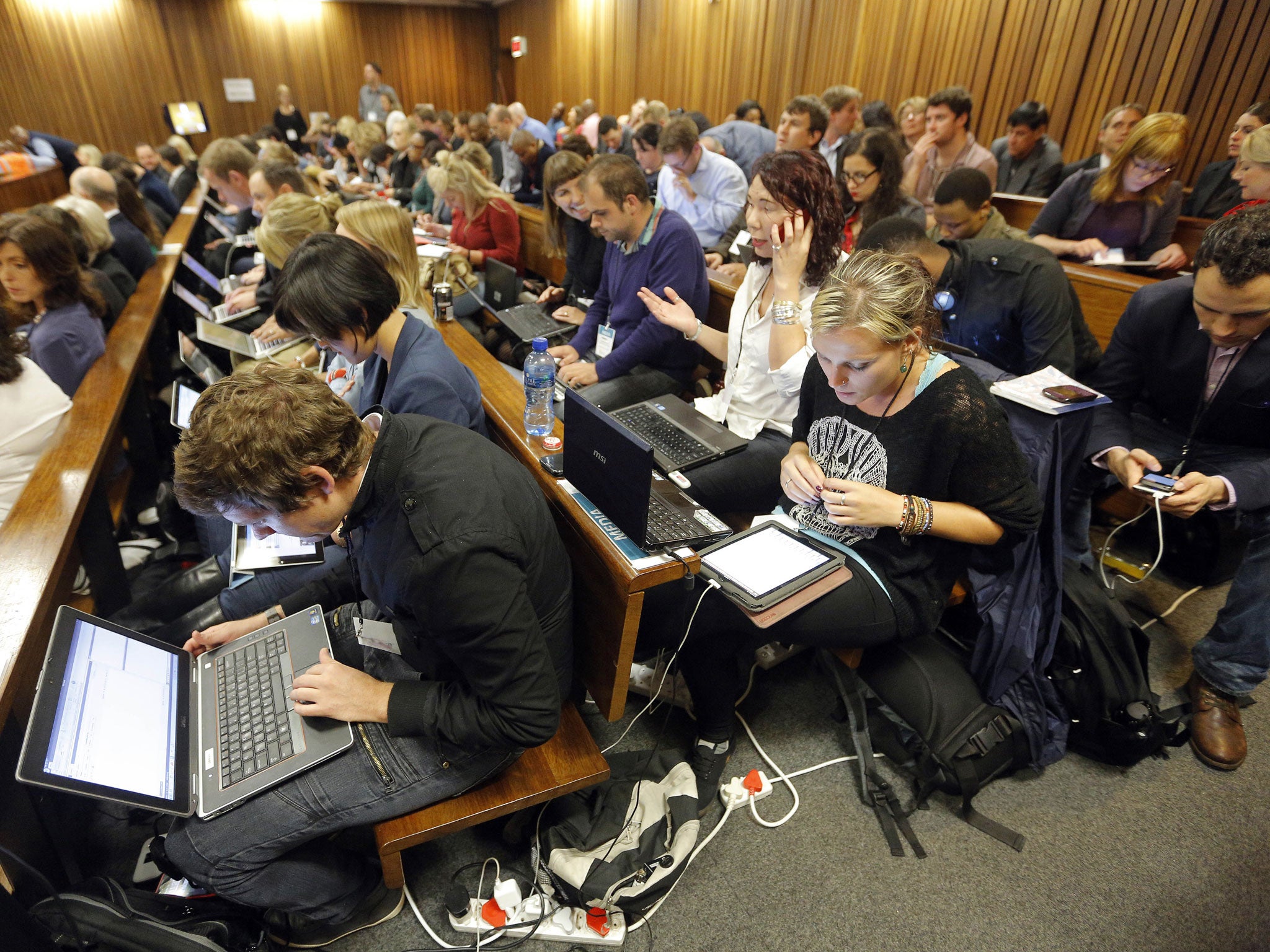 Members of the media work during a break in proceedings at the North Gauteng High Court in Pretoria (Getty Images)