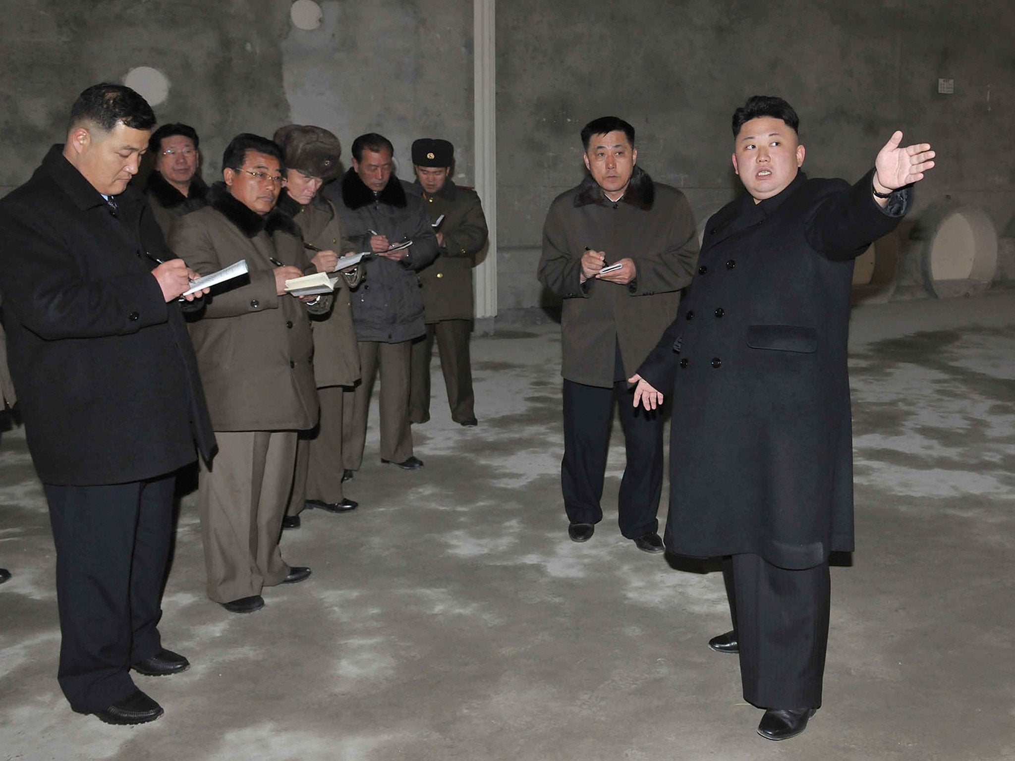 Kim Jong-Un points at remodeled building of the Songdowon International Children's Camp in Kangwon Province