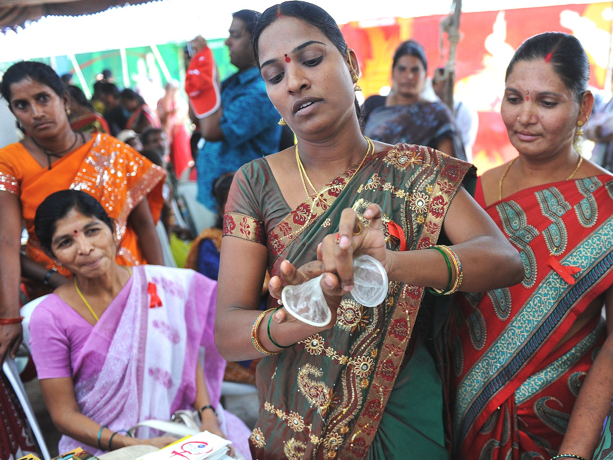 A new twist: volunteers explain the use of the female condom in India