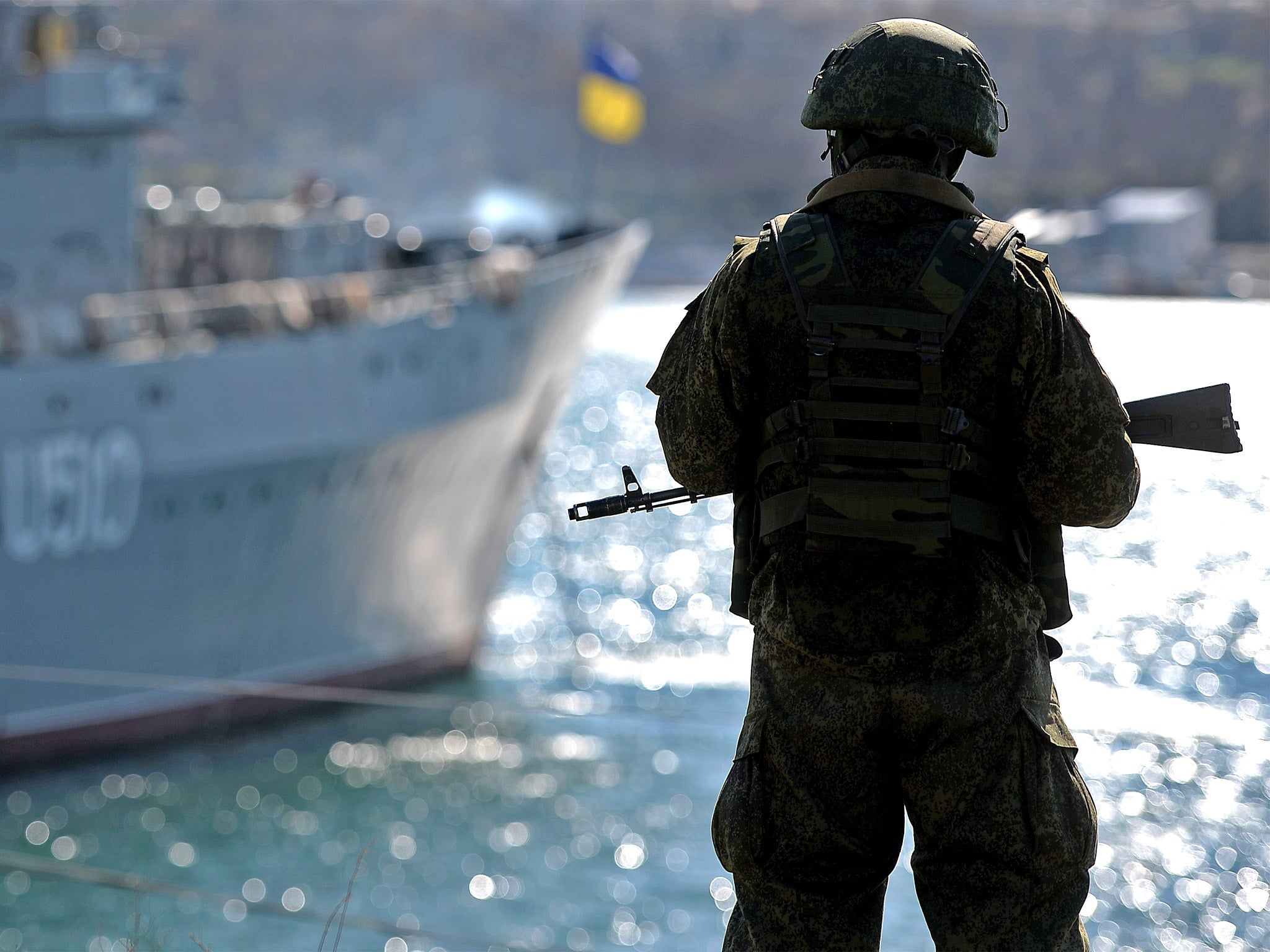 A member of the Russian troops stands guard in the harbor of Sevastopol