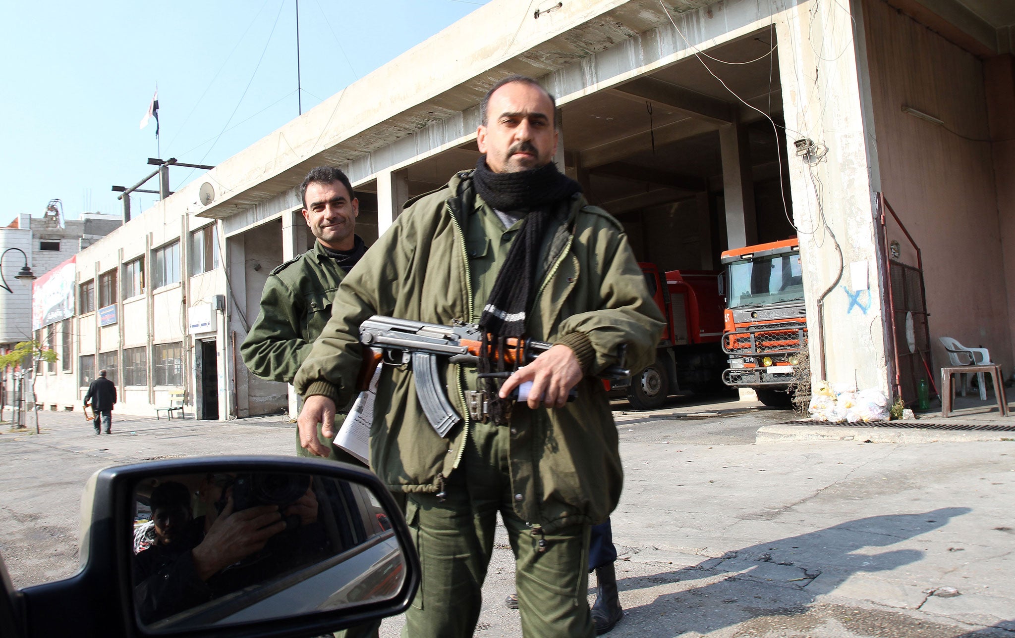 Syrian security forces guarding the main road in Homs