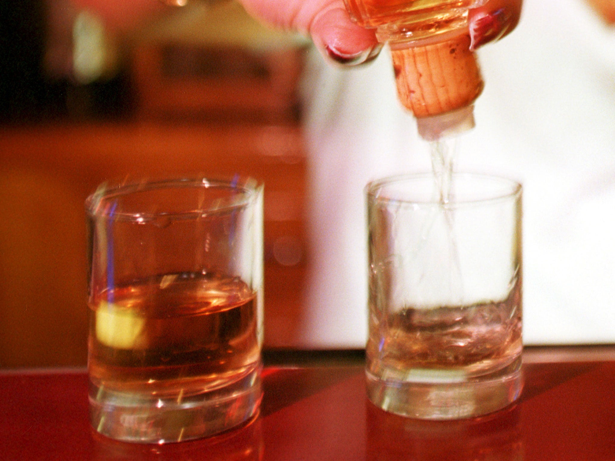 A bartender pours