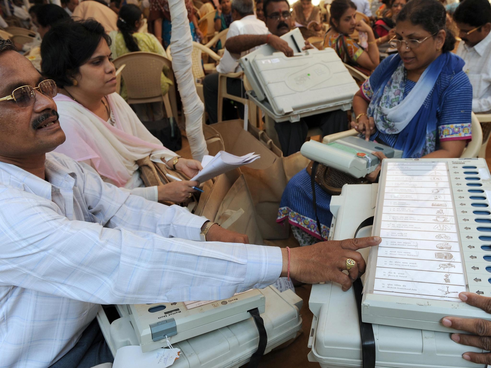 Indian election officials inspect Electronic Voting Machines