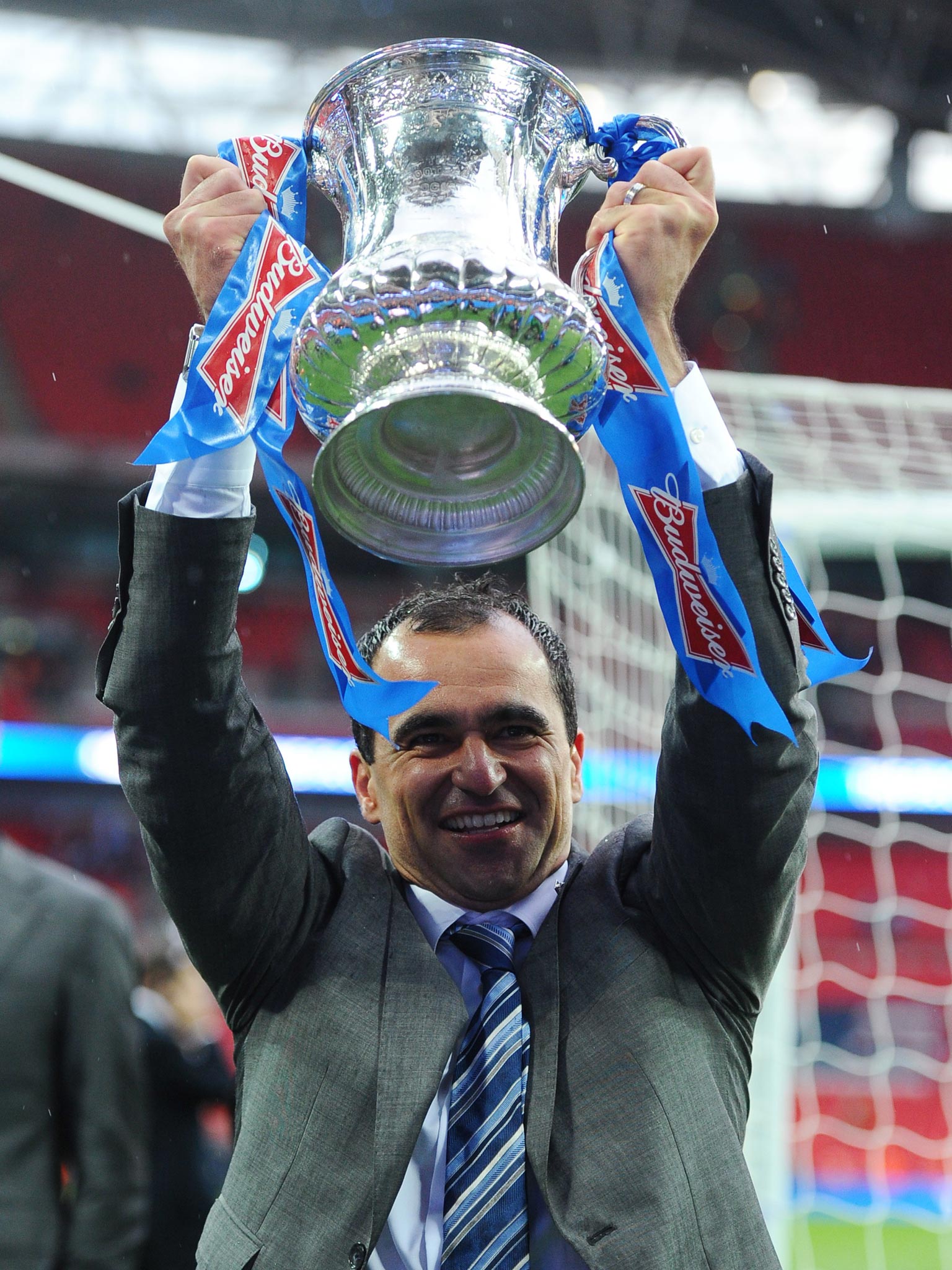 Roberto Martinez, here lifting the FA Cup with Wigan, is still on
course for a managerial first by retaining it with Everton