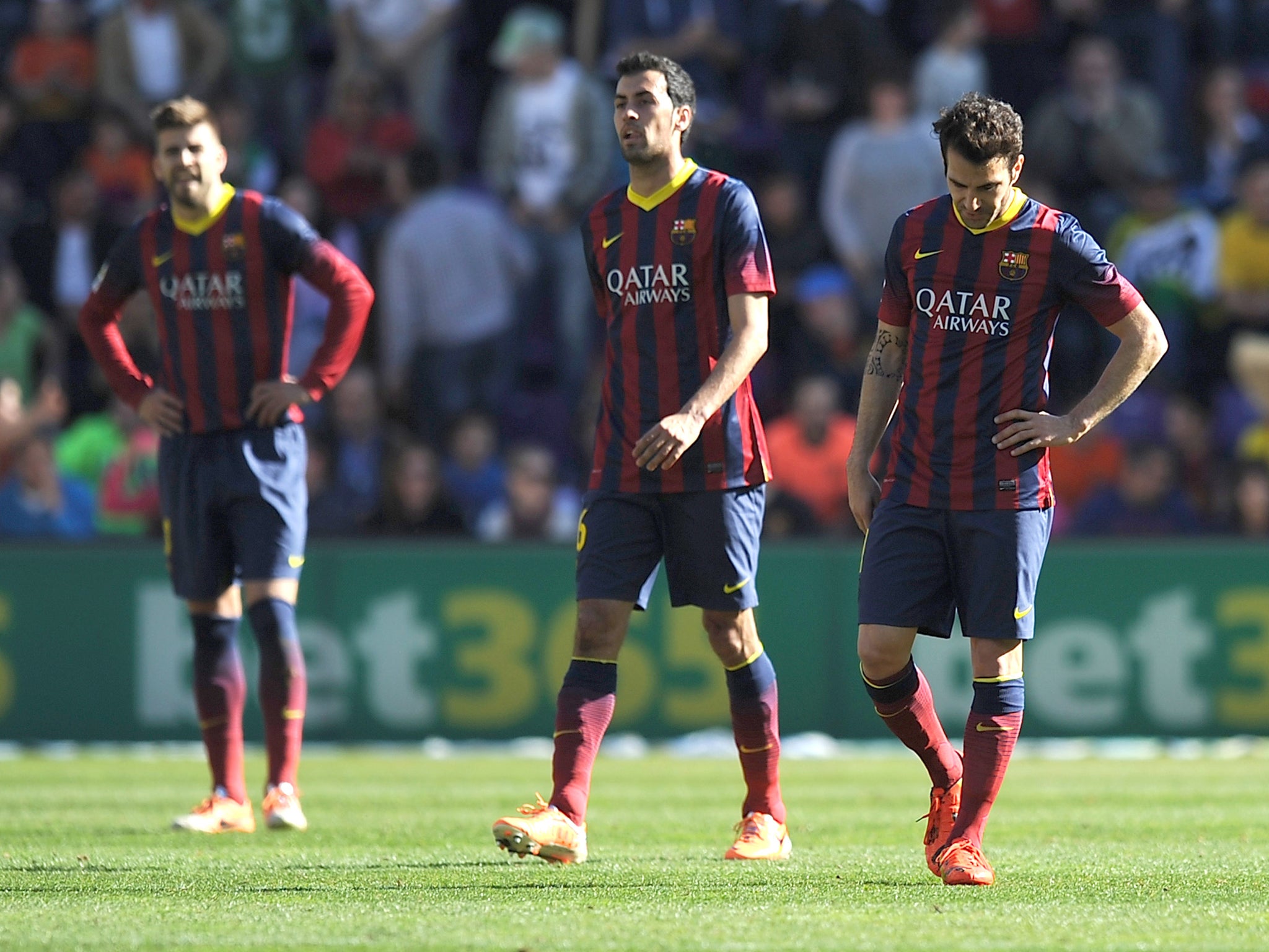 Gerard Pique, Sergio Busquets and Cesc Fabregas react to Barcelona's defeat against Valladolid