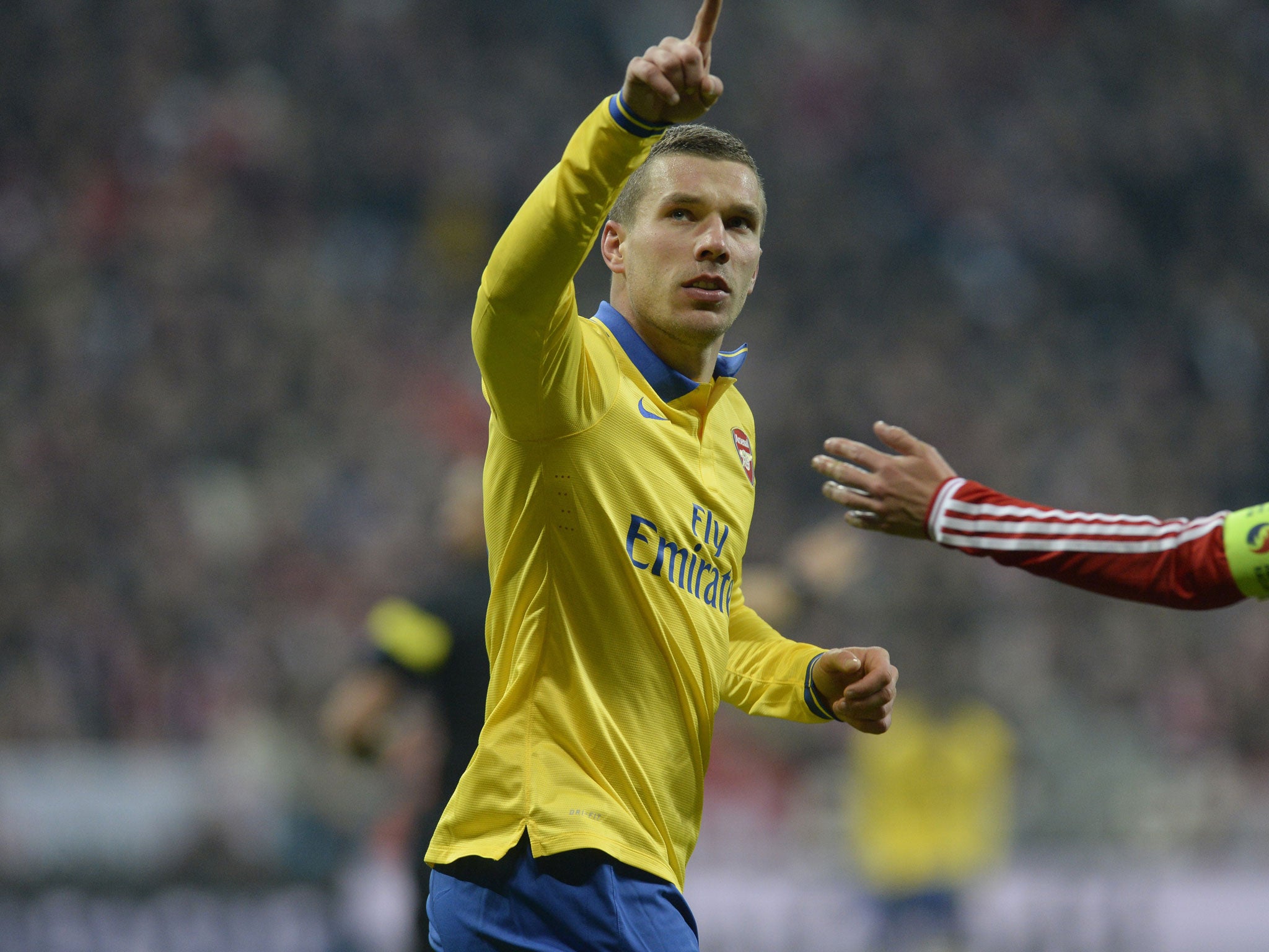 Lukas Podolski celebrates his goal against his former team