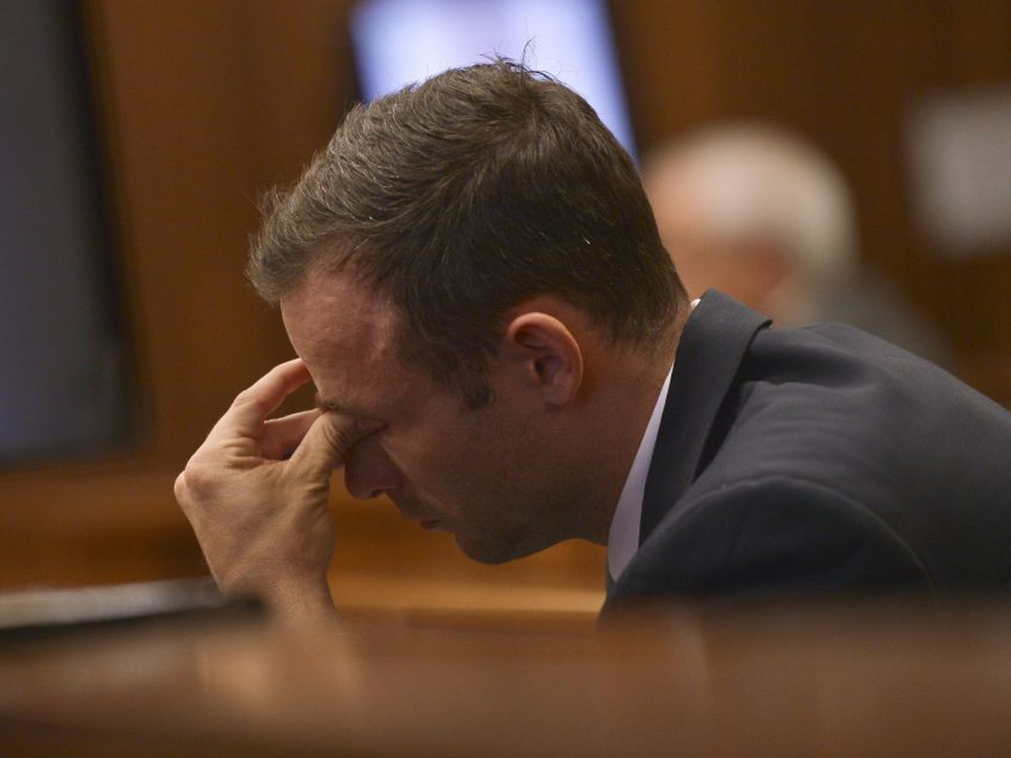 Oscar Pistorius looked down as the scene of the crime was shown in court