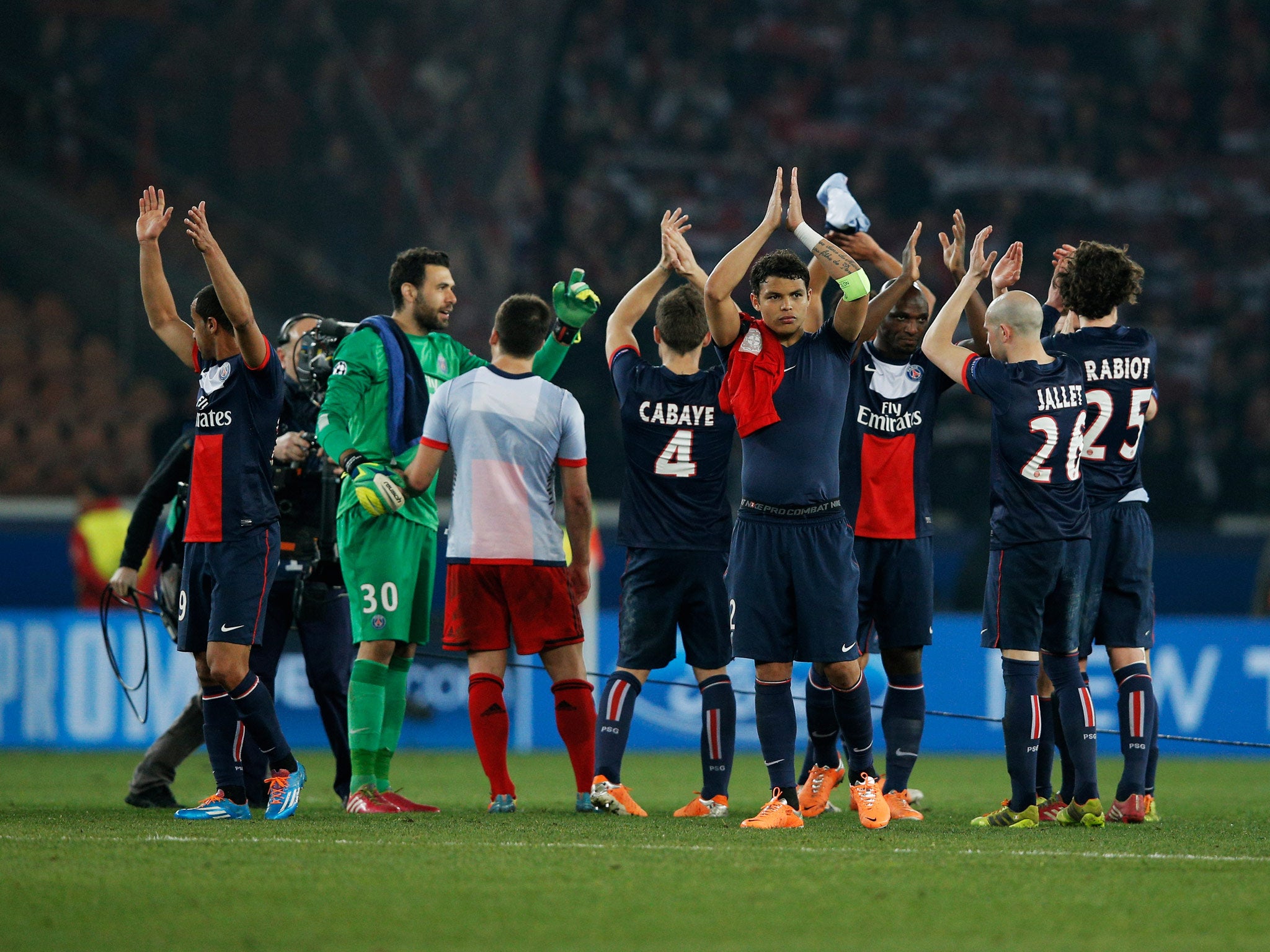 PSG players celebrate victory after the Champions League Round of 16 second leg match against Bayer Leverkusen at Parc des Princes