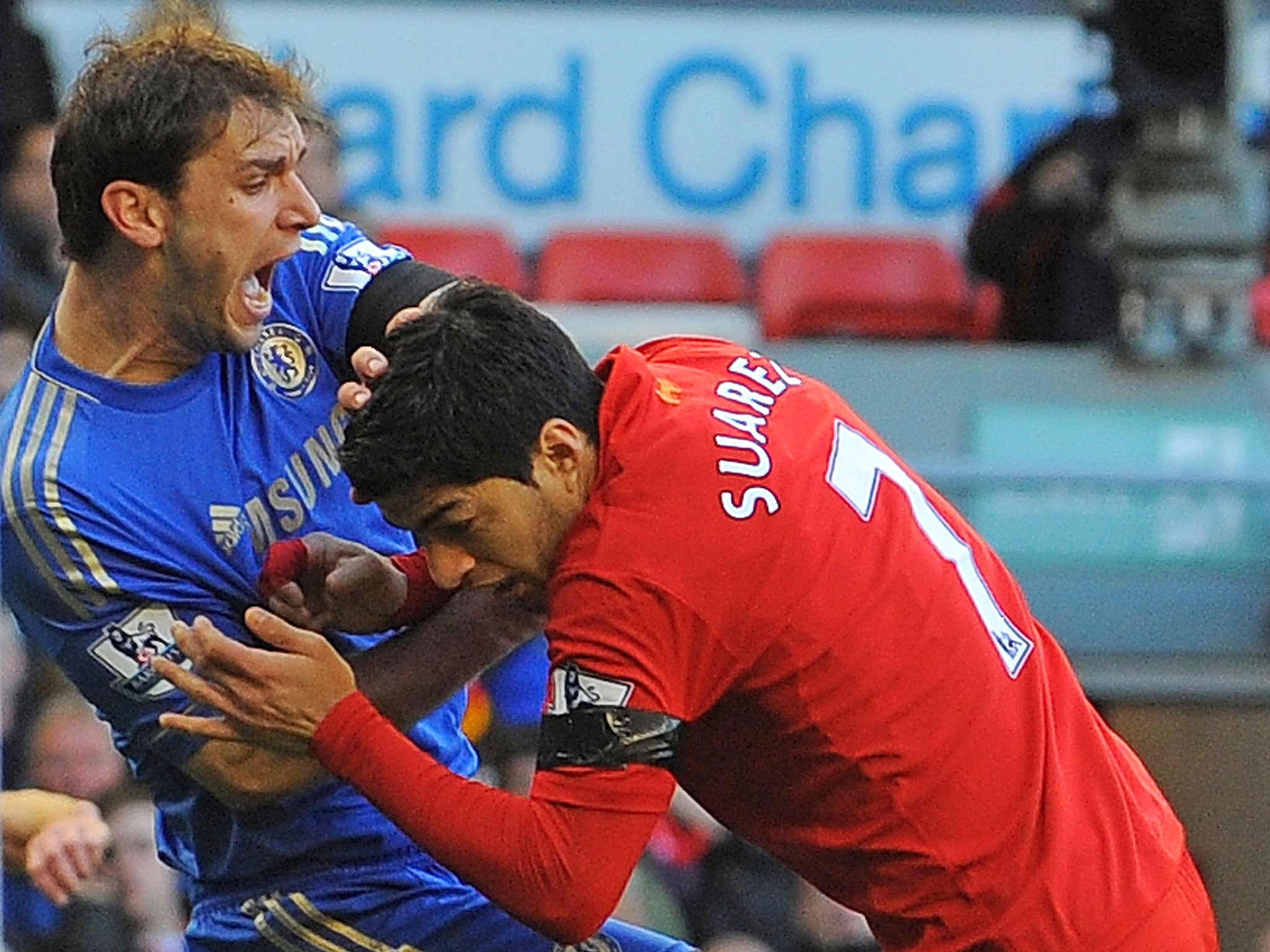 Uruguayan striker Luis Suarez (R) clashes with Chelsea's Serbian defender Branislav Ivanovic (L)