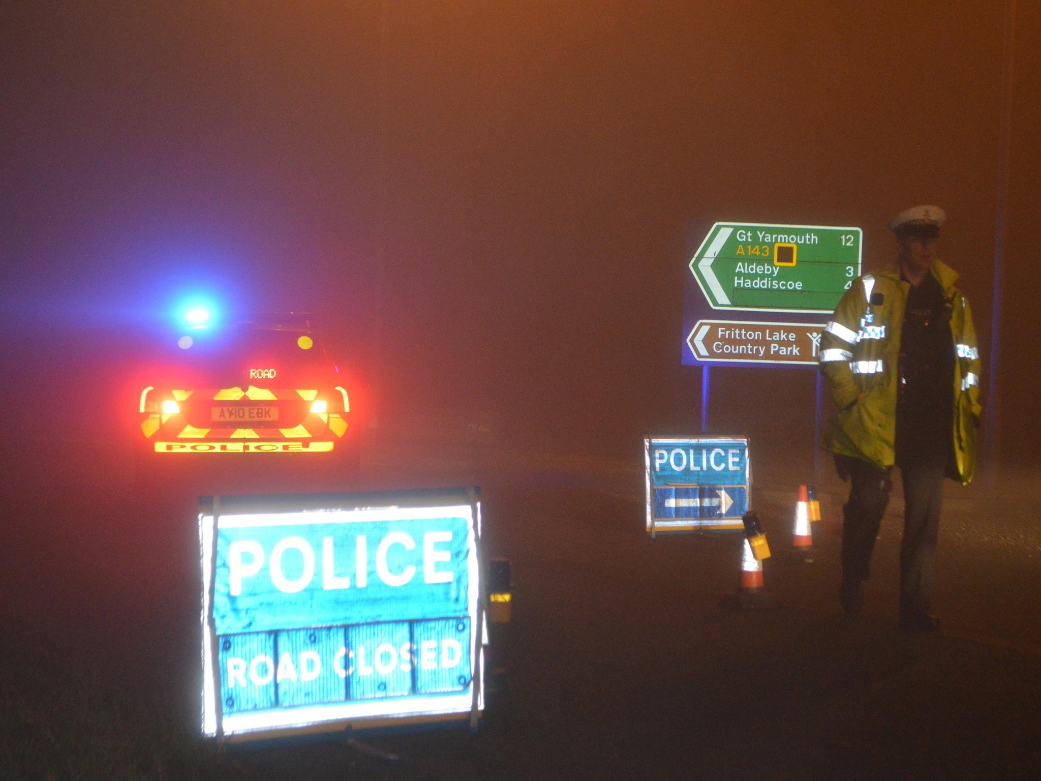 Police man a road block in Gillingham, near Beccles, Norfolk, as emergency services are attend to a helicopter crash