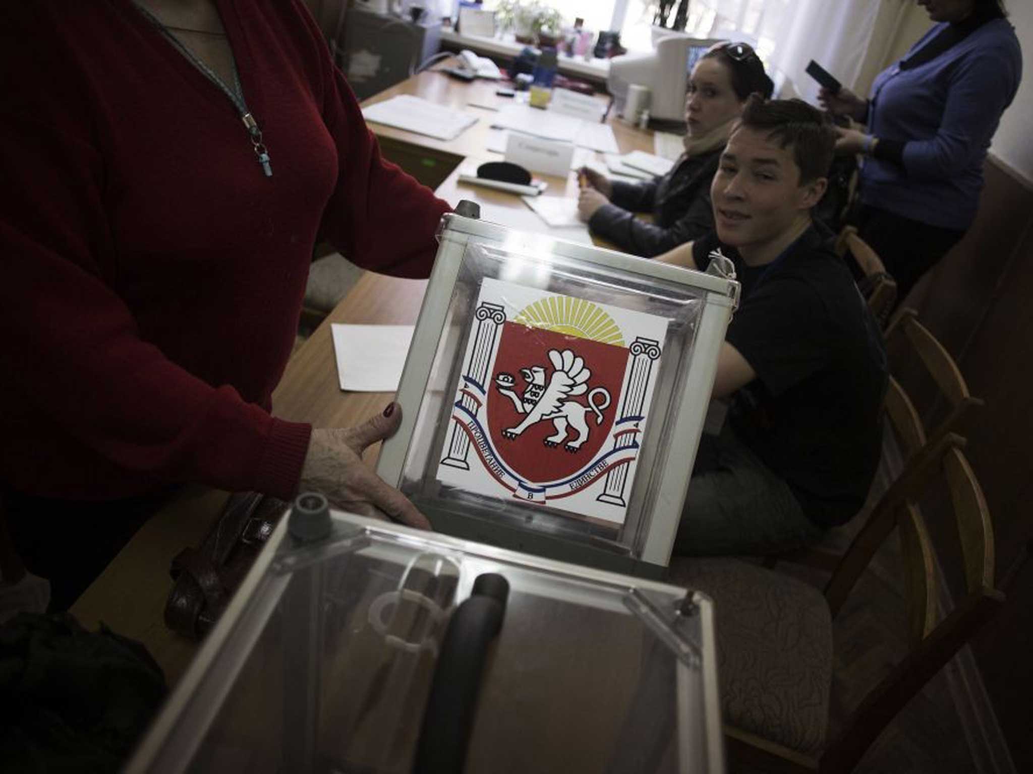 Action stations: Preparations for today’s referendum in Simferopol, where Crimea will vote to become part of Russia