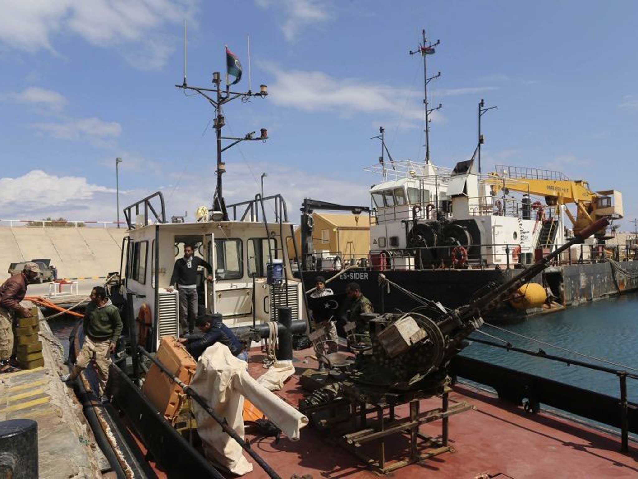 Call to arms: Rebels unload ammunition in Ras Lanuf last week