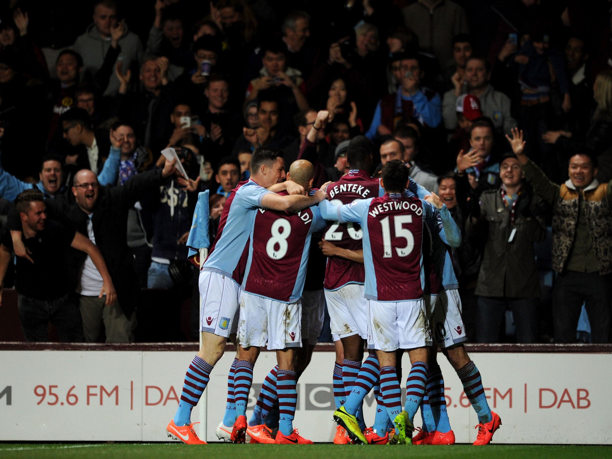 Fabian Delph of Aston Villa (obscured) is congratulated by team mates as he scores their first goal