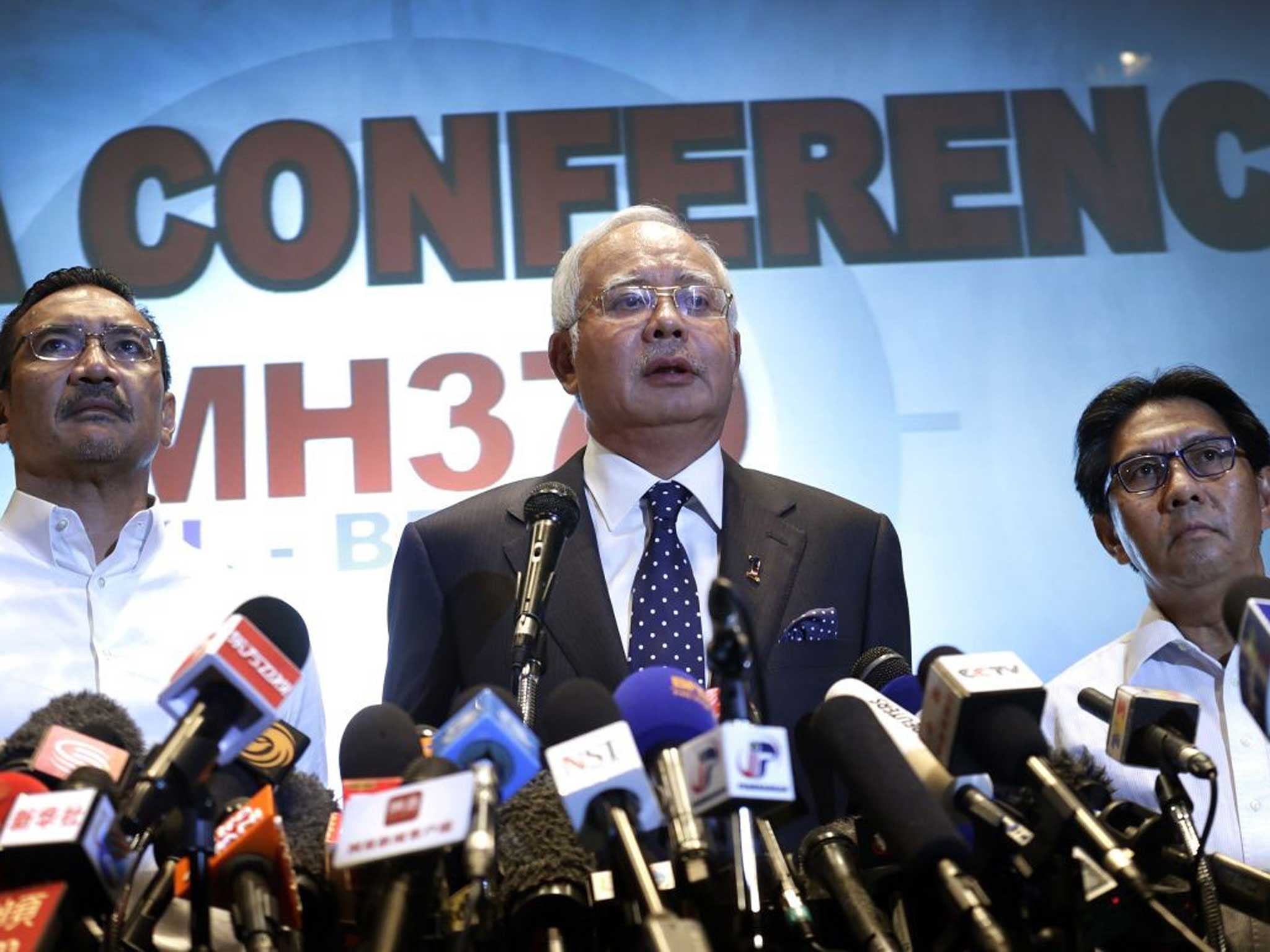 Malaysian Prime Minister Najib Razak, center, Malaysia's minister for transport Hishamuddin Hussein, left, and director general of the Malaysian Department of Civil Aviation, Azharuddin Abdul Rahman