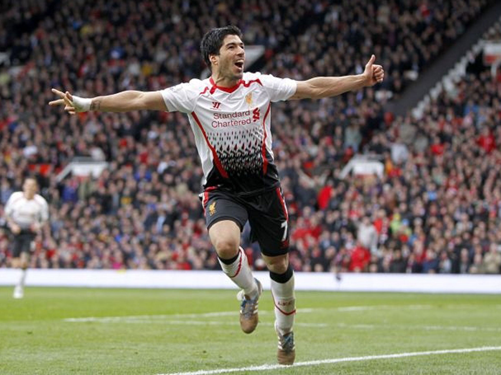 Luis Suarez celebrates after making it 3-0 to Liverpool at Old Trafford