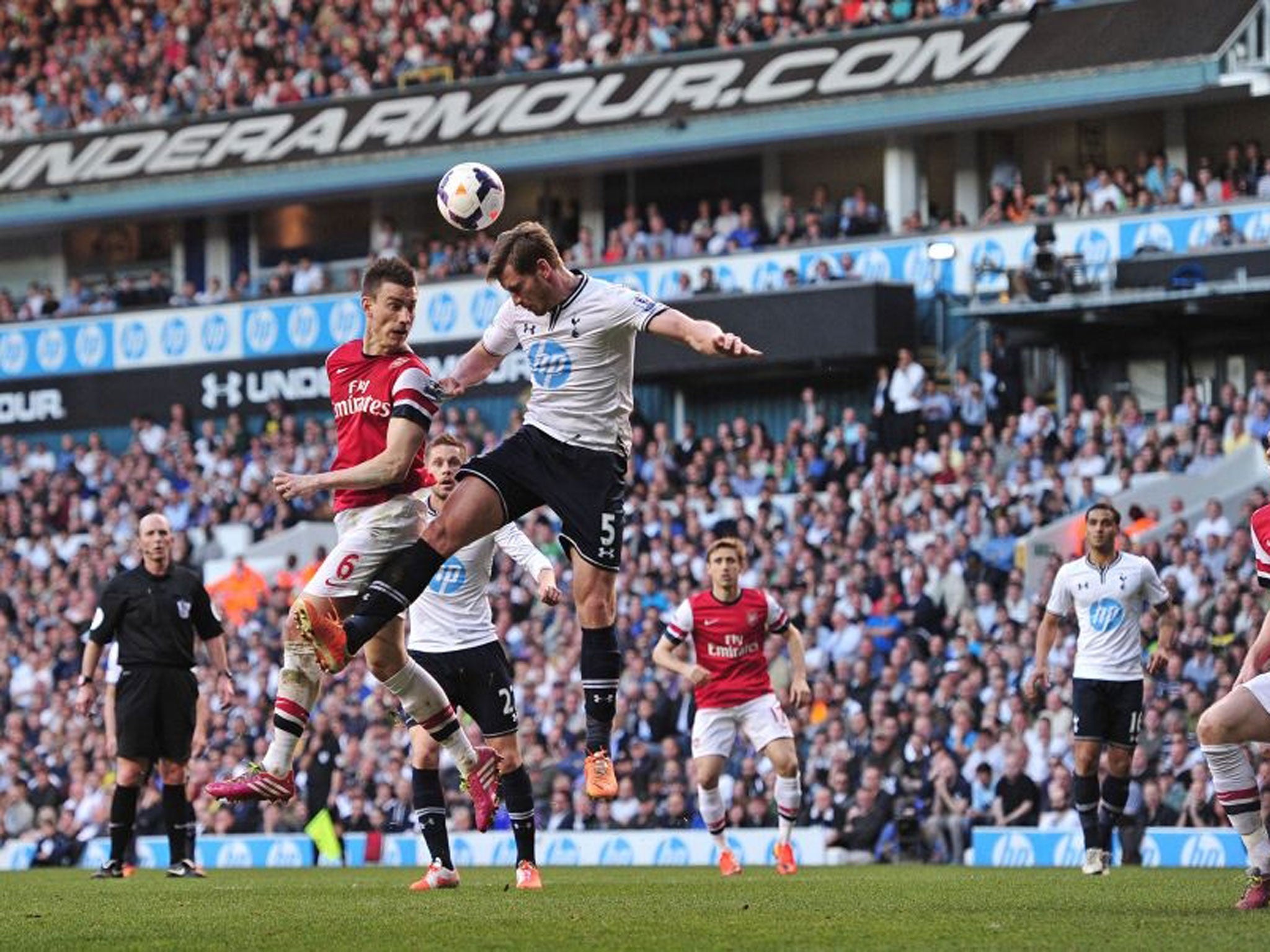 Arsenal's French defender Laurent Koscielny (2nd L) challenges Tottenham Hotspur's Belgian defender Jan Vertonghen (4th L) in the air during the match between Tottenham Hotspur and Arsenal at White Hart Lane