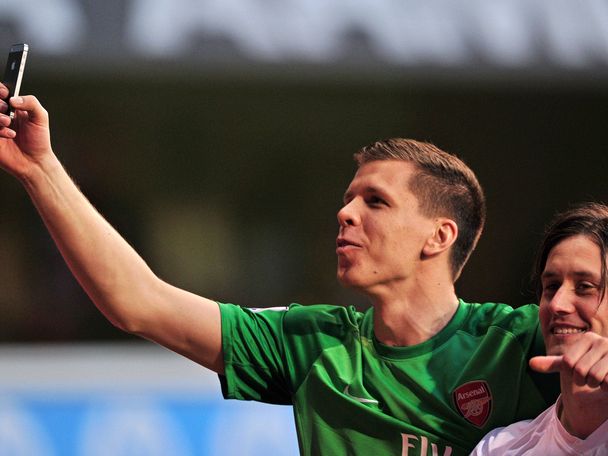 Wojciech Szczesny(left) wields his camera-phone after the victory at White Hart Lane. He later uploaded a different 'selfie' on his Facebook page