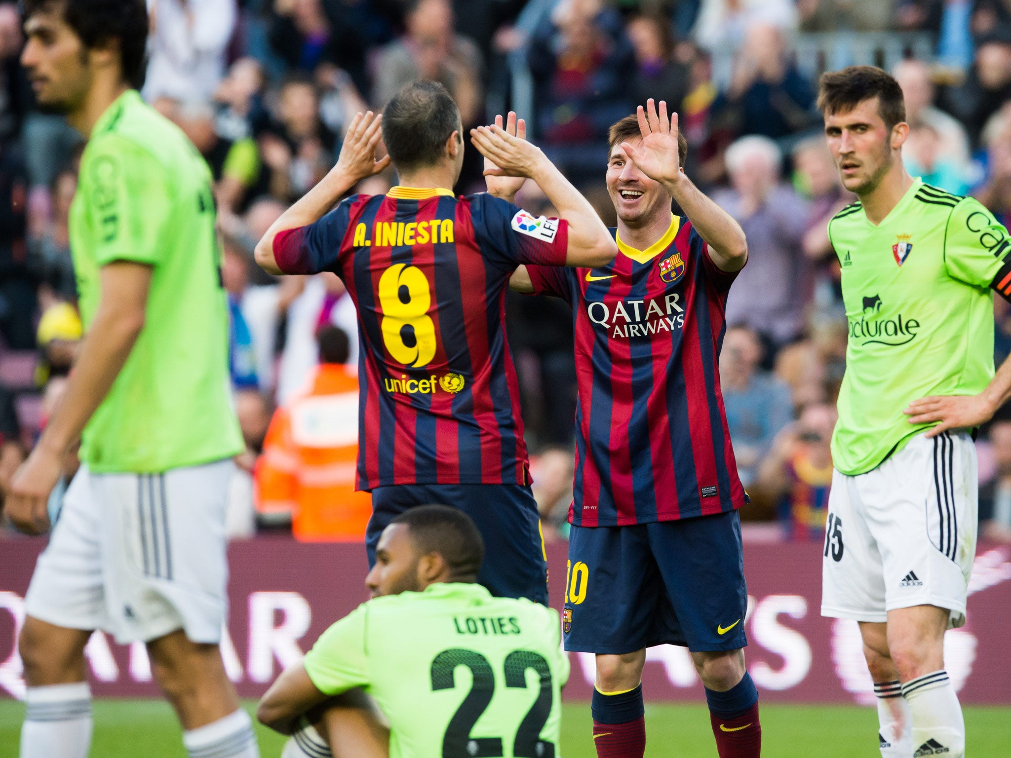 Lionel Messi pictured celebrating with Andres Iniesta on his way to a hat-trick in a 7-0 win over Osasuna