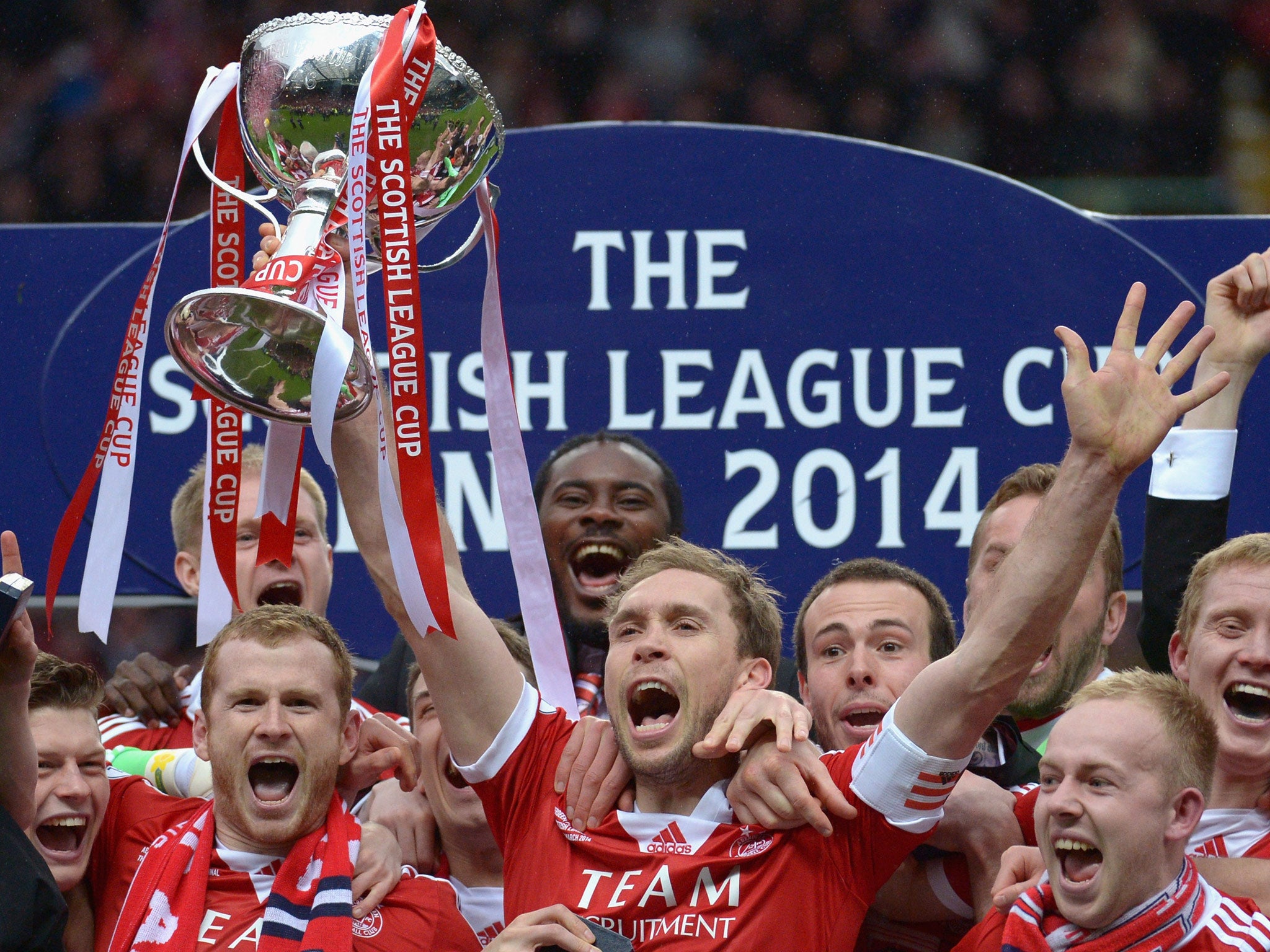 Russell Anderson of Aberdeen lifts the Scottish Communities League Cup Final at Celtic Park Stadium