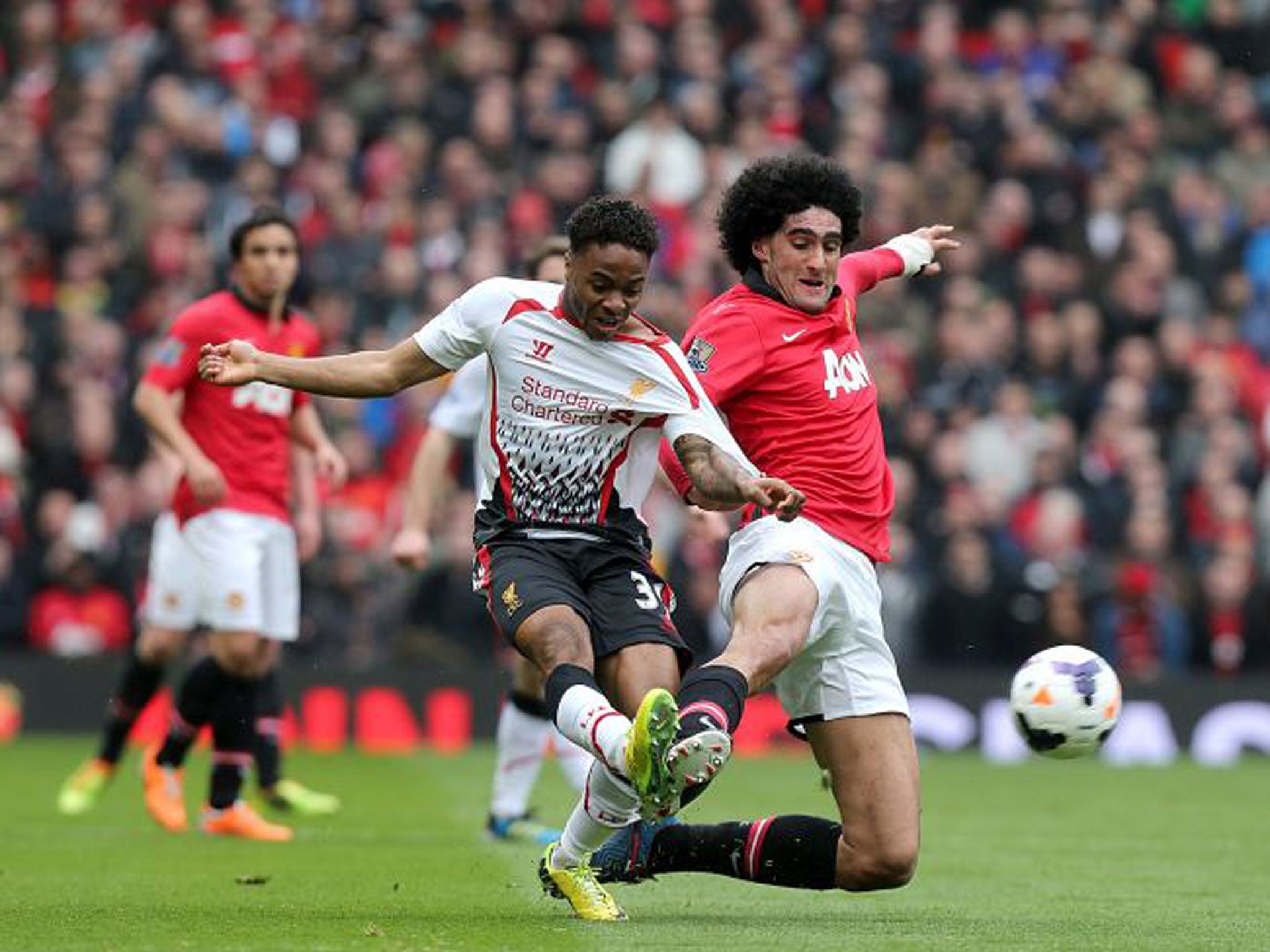 Marouane Fellaini, right, struggles to contain Raheem Sterling on Sunday