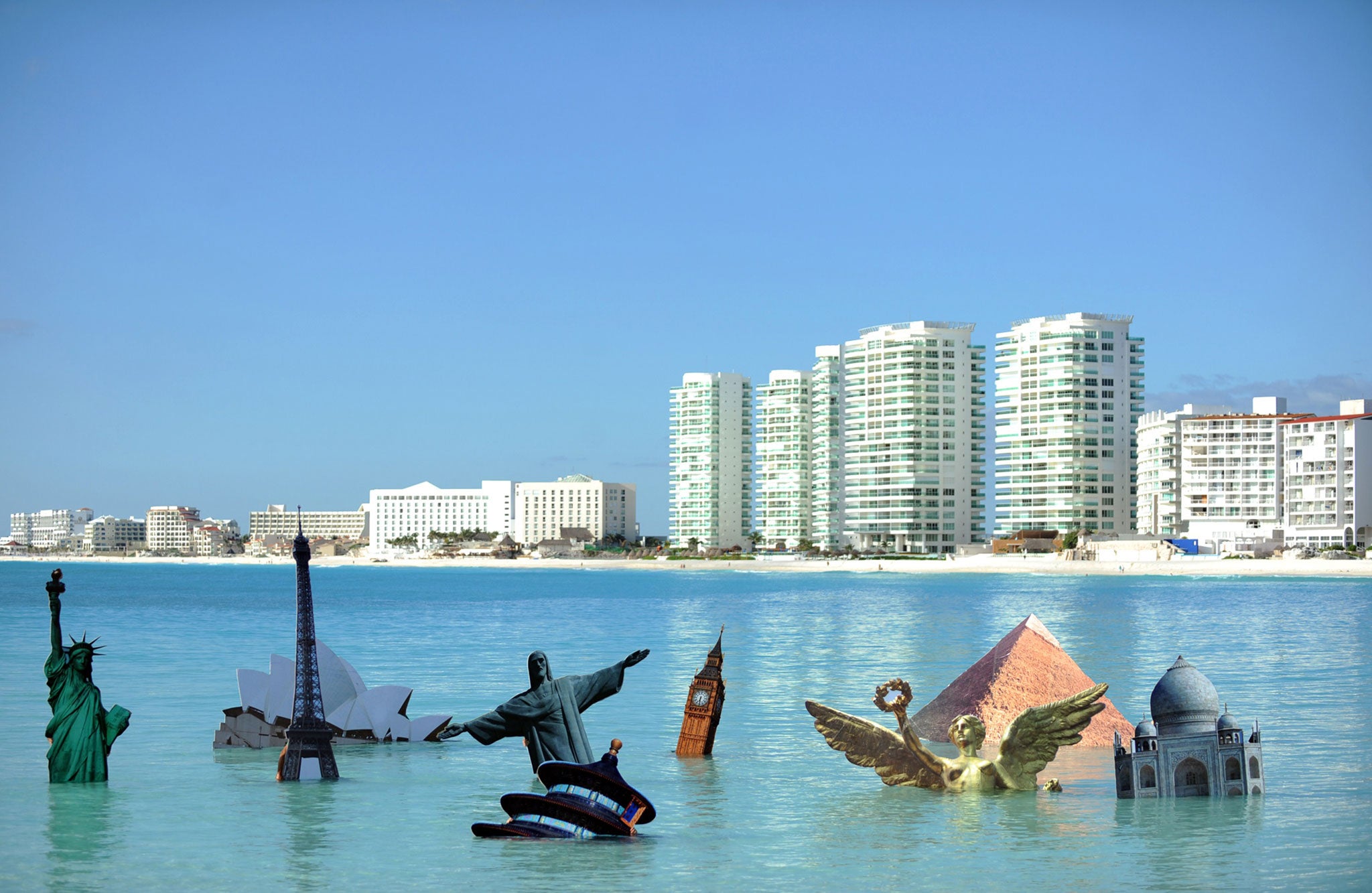 Activists of Greenpeace perform their symbolic 'Sinking Icons' activity, by submerging icons of world famous buildings, in Cancun, Mexico