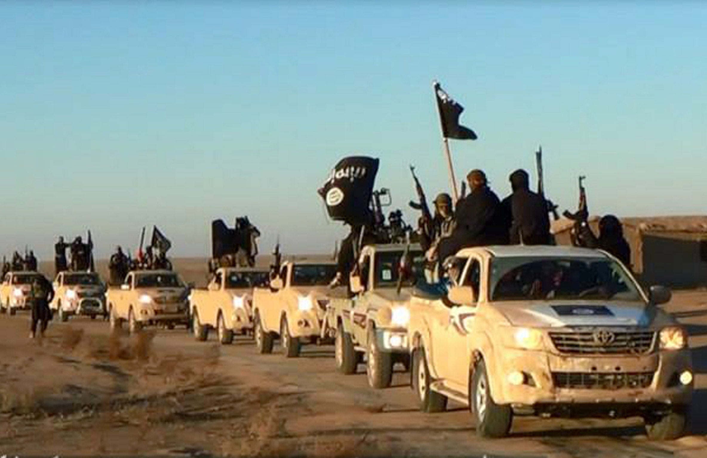 A convoy of vehicles carrying Isis militants in Fallujah