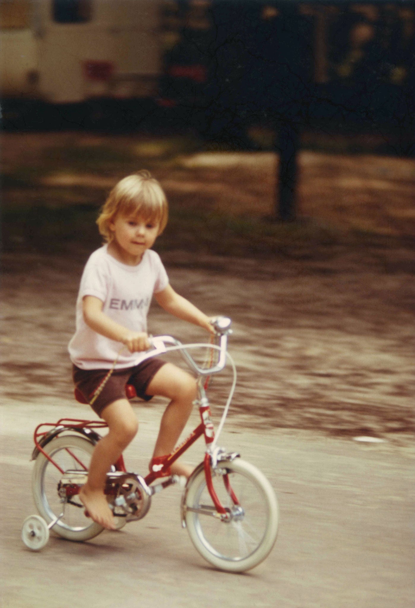 Emma as a four-year-old cycling around a French campsite on her favourite red bike