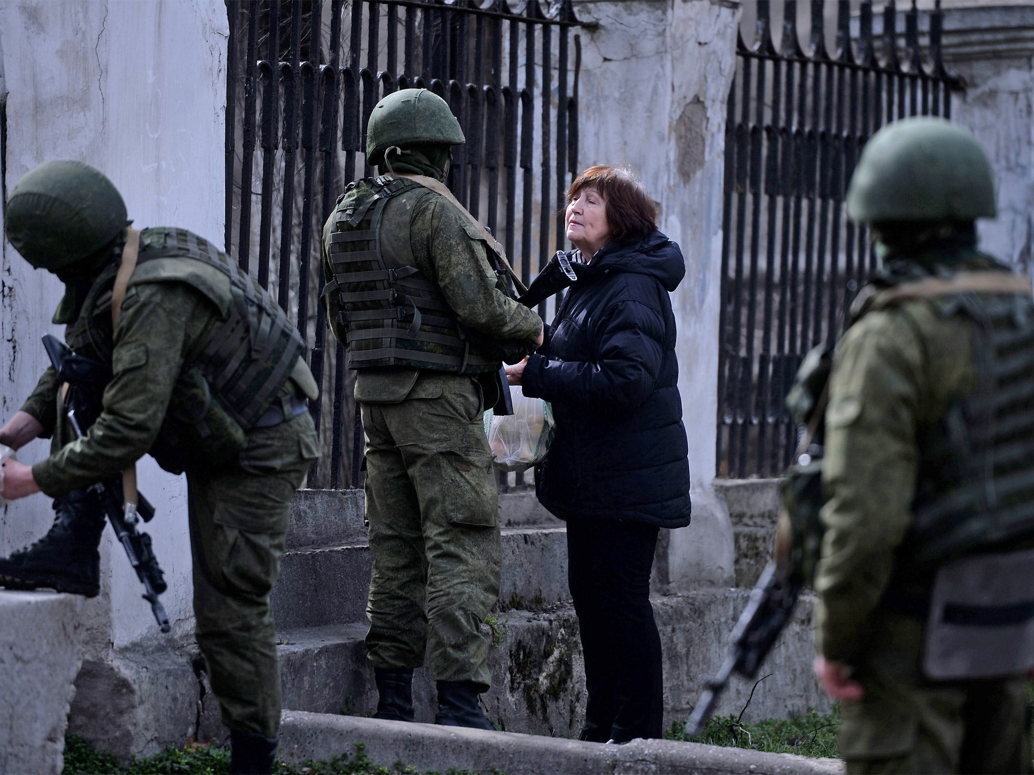 A woman remonstrates with Russian troops at the Simferopol naval base (Getty)