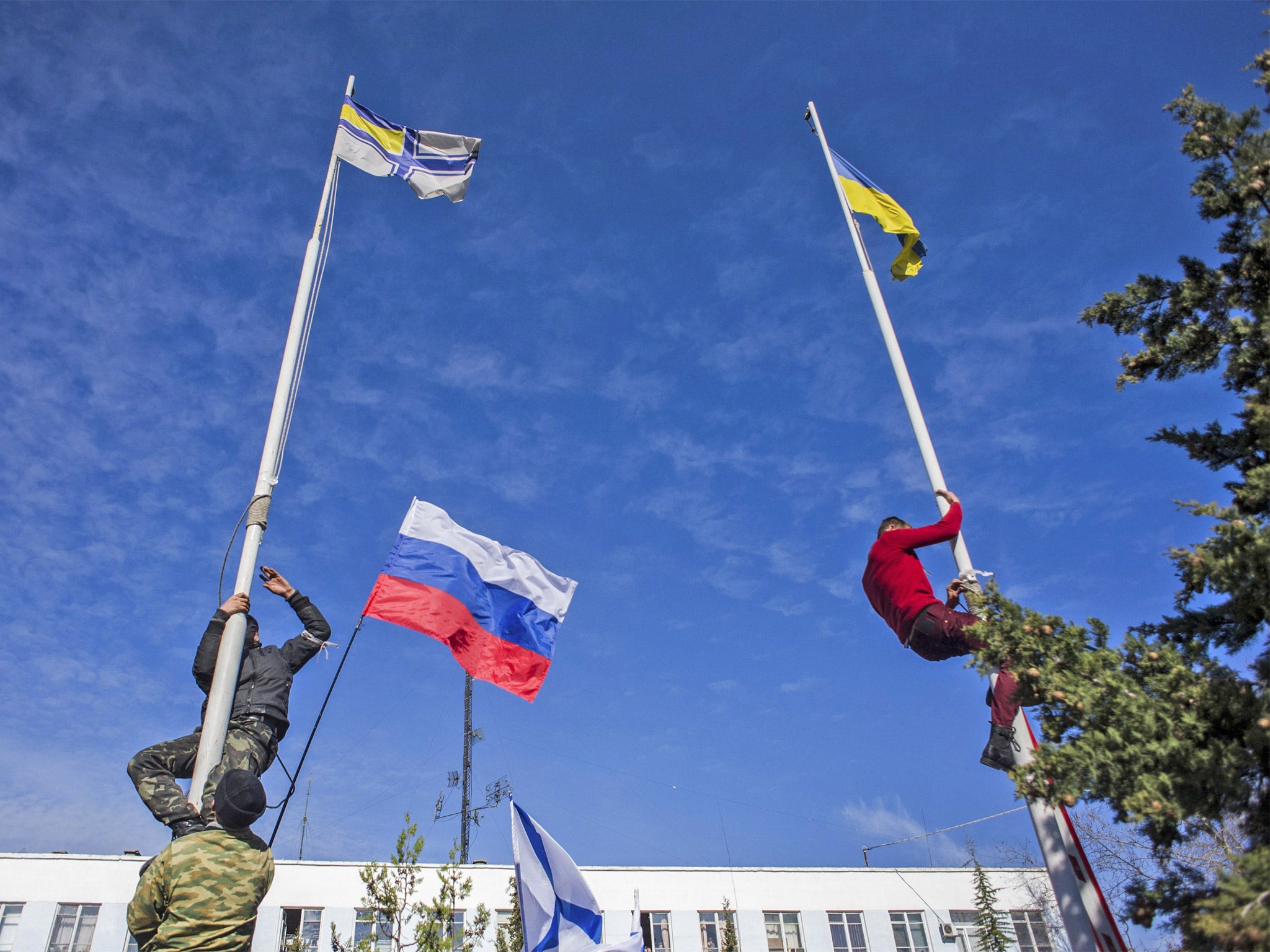 Pro-Russian forces take down Ukrainian flags at the naval base in Sevastopol