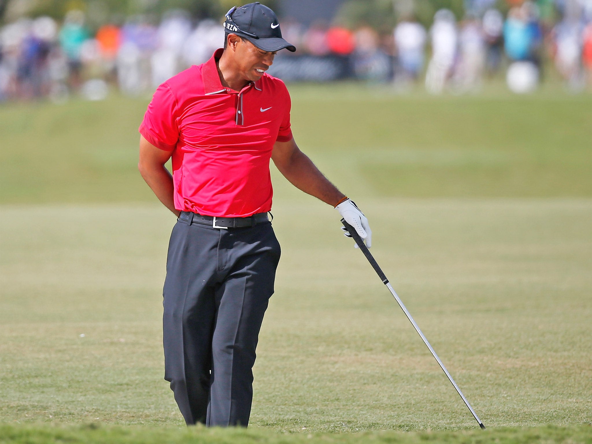 Tiger Woods clutches his painful lower back at Doral a fortnight ago