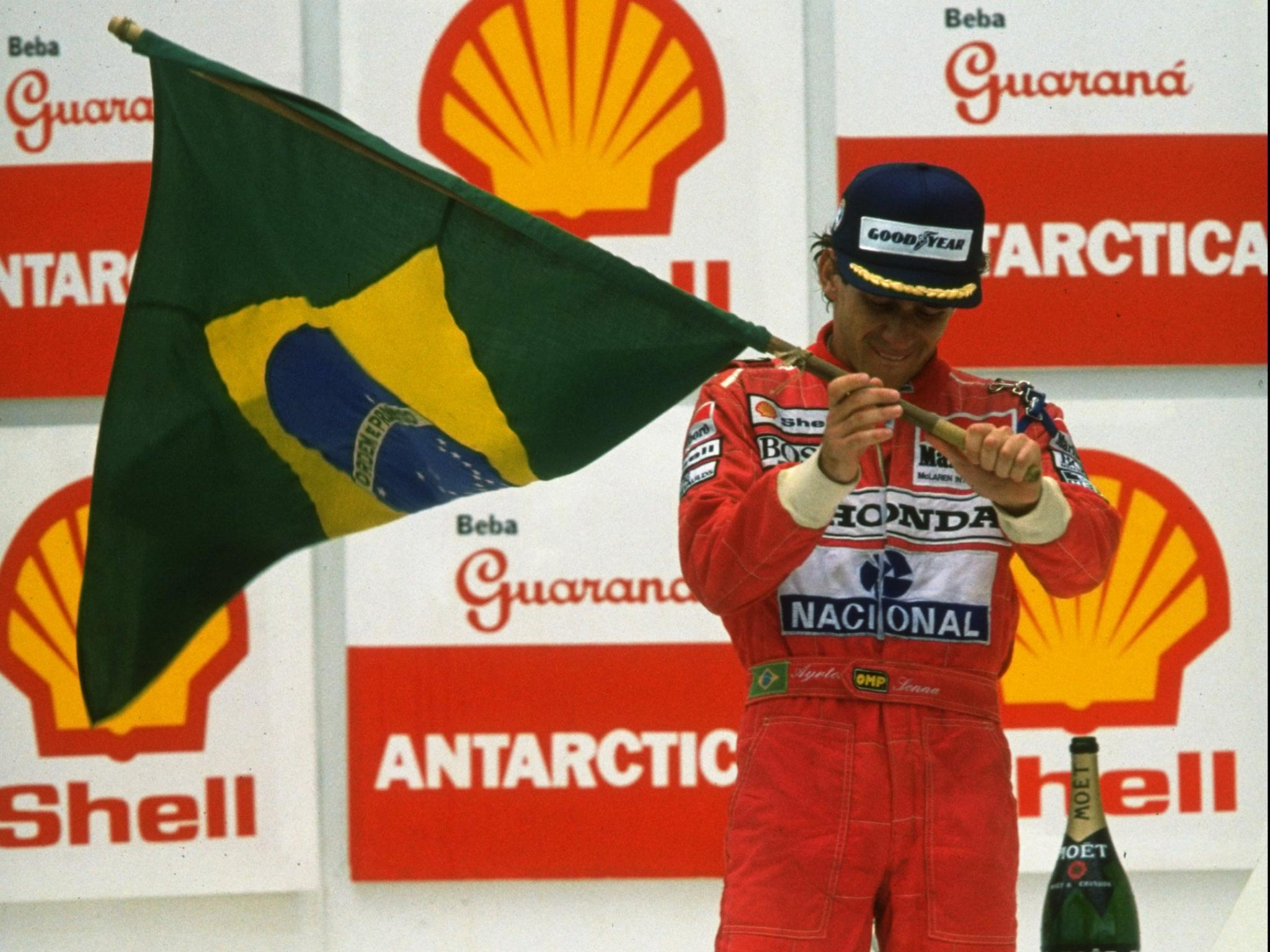 Ayrton Senna lifts the Brazilian flag after winning the 1991 Brazil Grand Prix