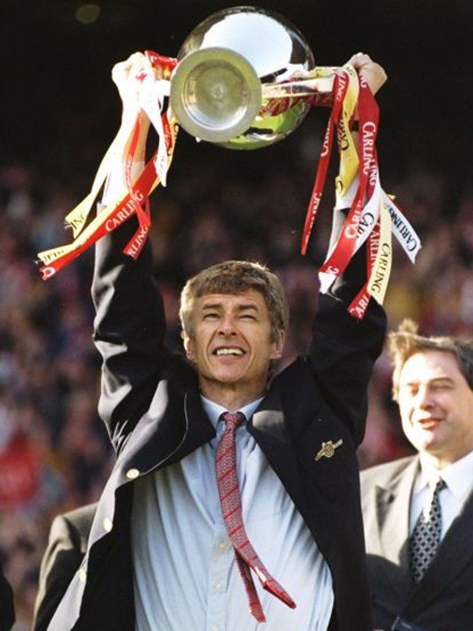 3 May 1998: Arsenal manager Arsene Wenger proudly lifts the championship trophy after the FA Carling Premiership match against Everton at Highbury in London