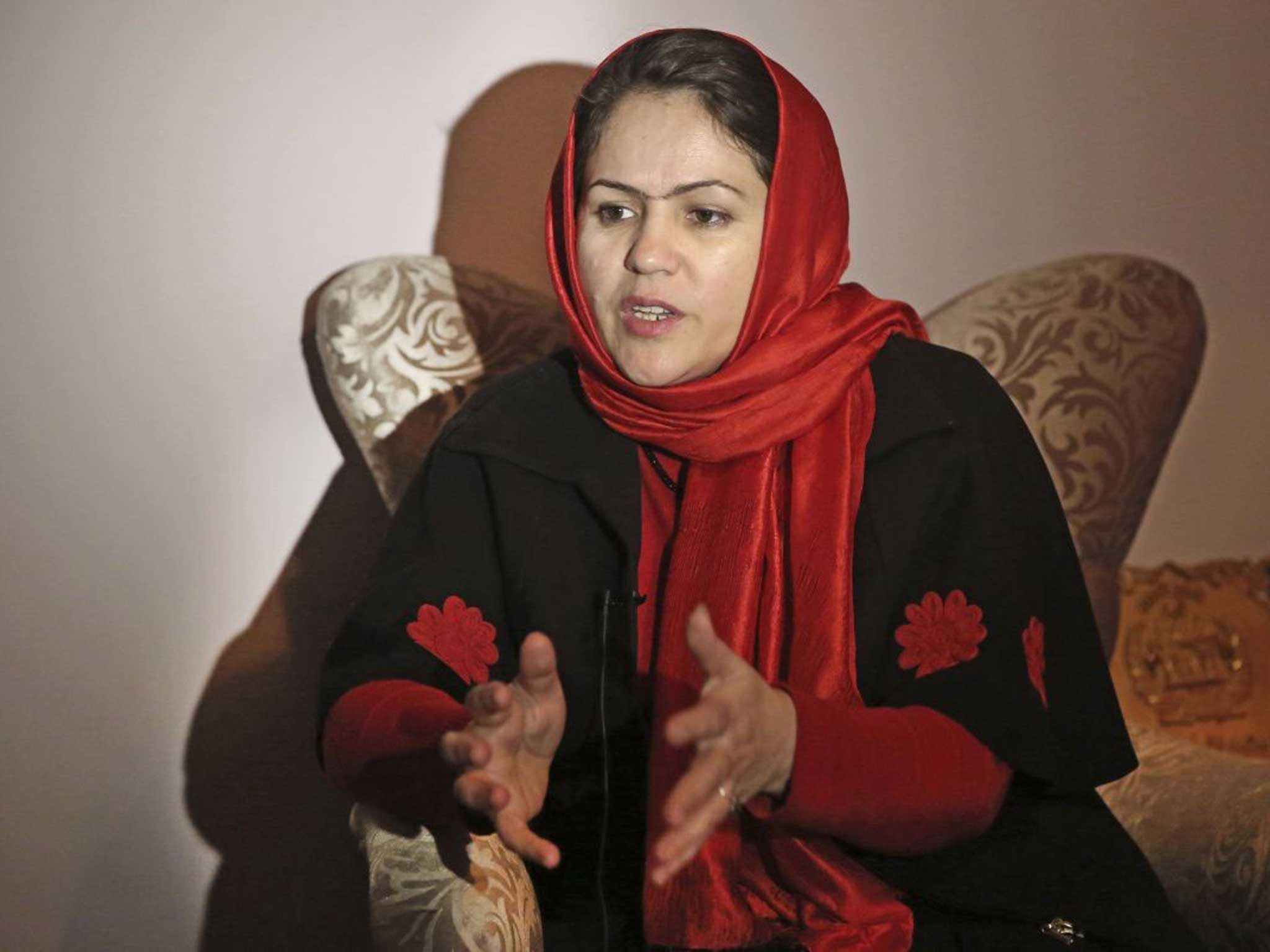 Afghan Parliamentarian Fawzia Koofi gestures during an interview - she is grateful to no longer wear the all-encompassing burqa