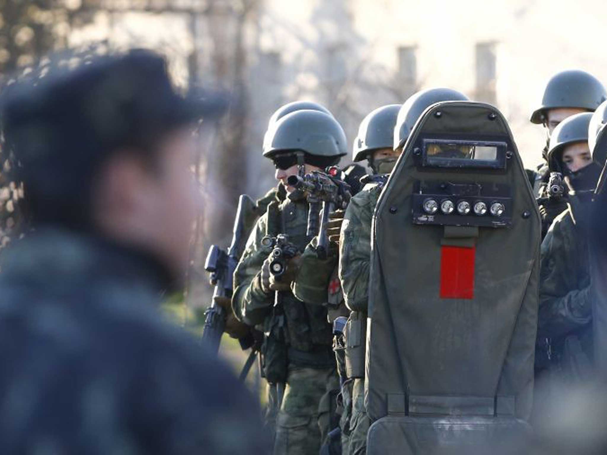 Surrender: Armed troops storm the Belbek base yesterday