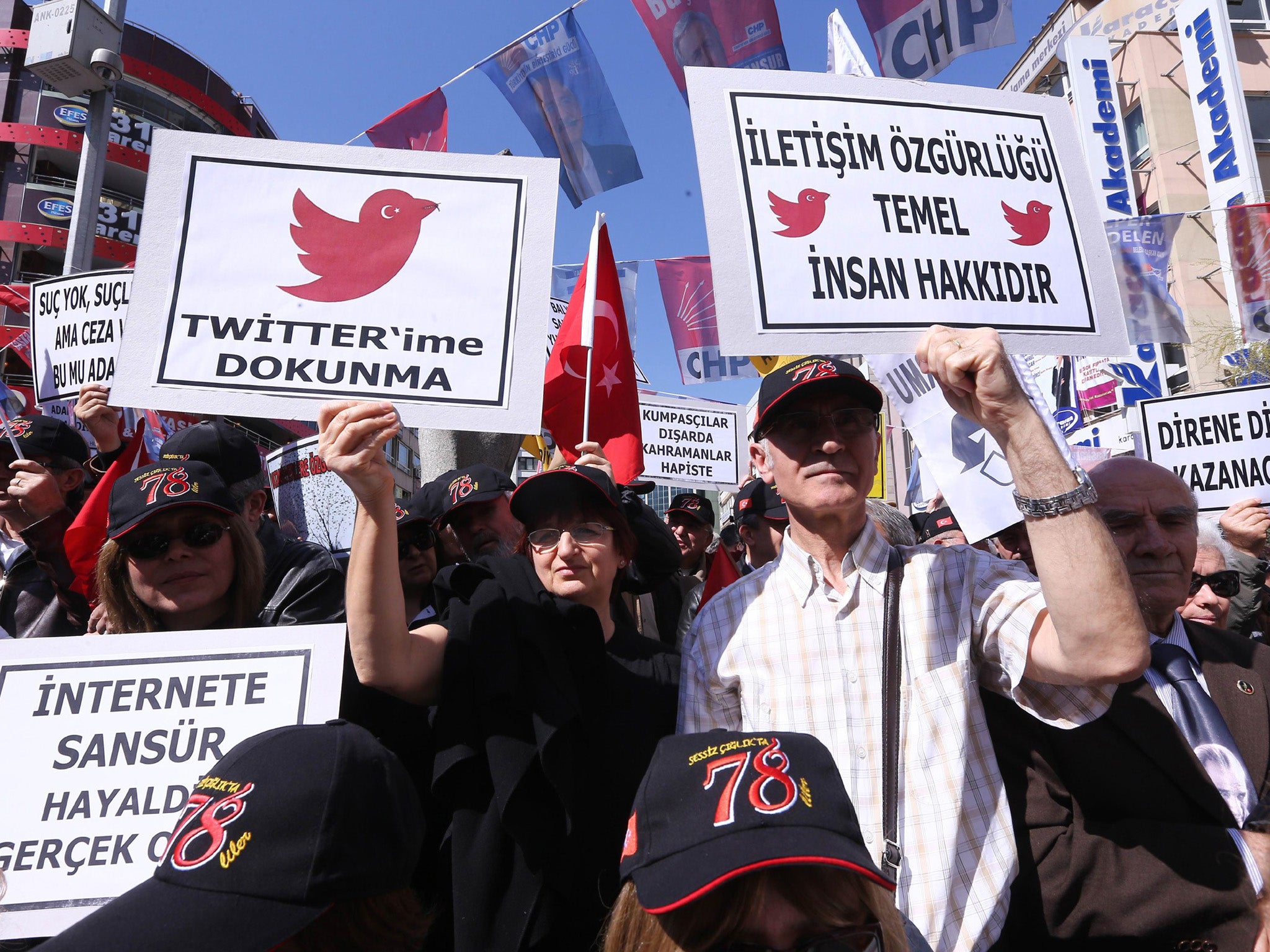 Protesters hold placards reading 'do not touch my twitter' and 'communication right is a basic human right' during a demonstration in Ankara against the Turkish ban on Twitter