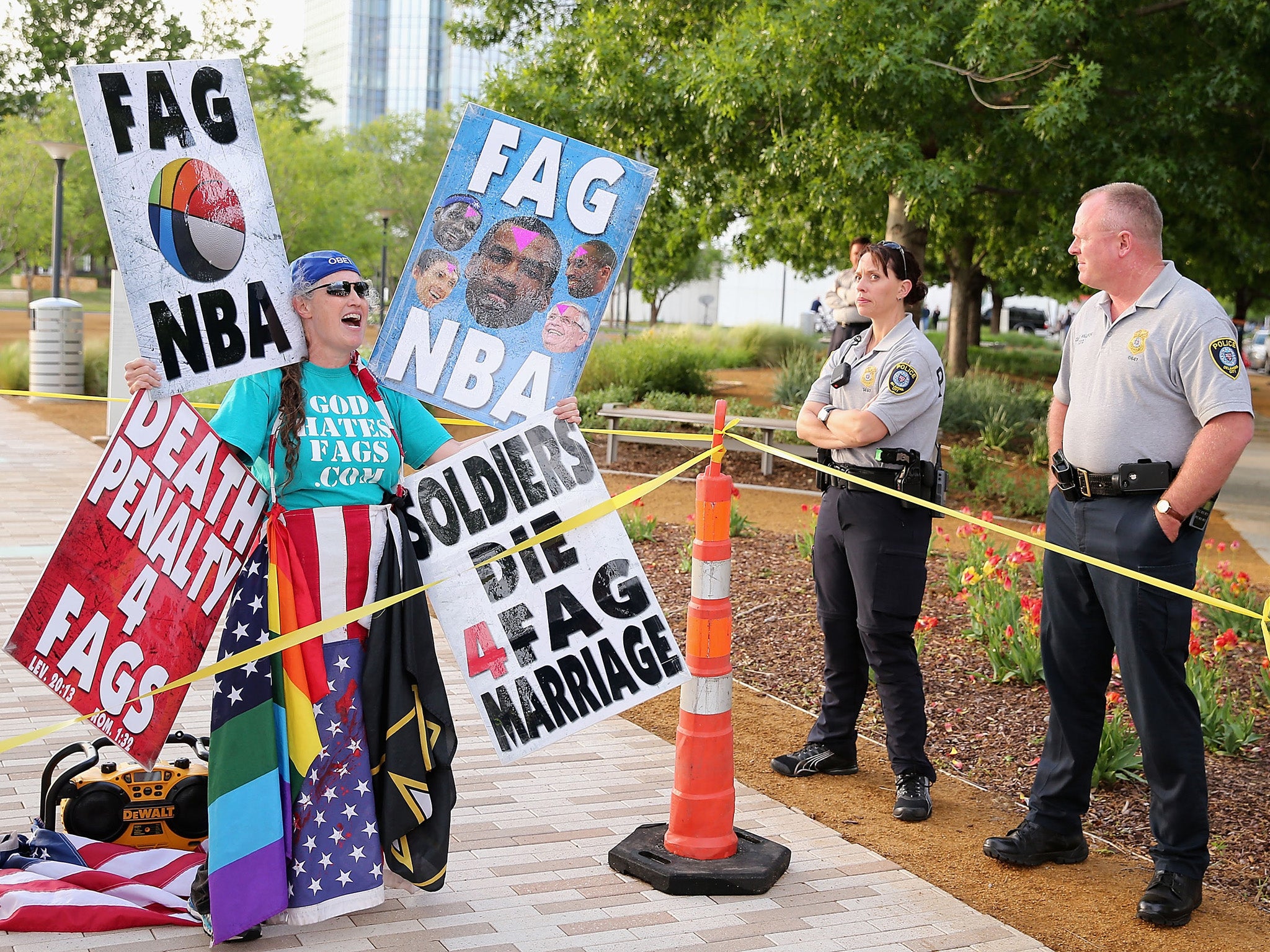 OKLAHOMA CITY, OK - MAY 01 2013: A member of the Westboro Baptist Church protests gay rights and the NBA as police officers look on before Game Five of the Western Conference Quarterfinals of the 2013 NBA Playoffs between the Oklahoma City Thunder and the