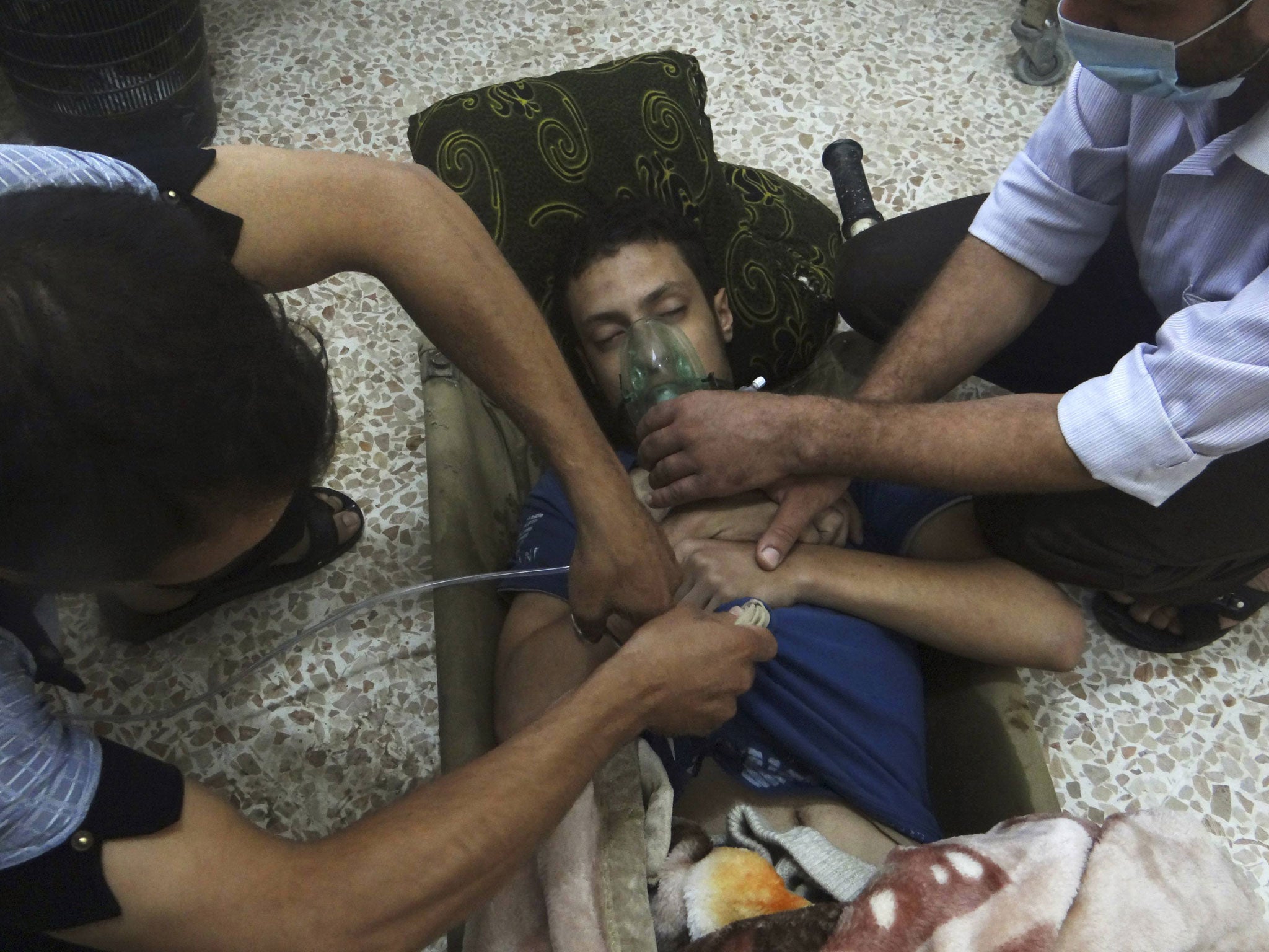 A man, reportedly injured by nerve gas, receives oxygen in the Damascus suburb of Jesreen. The UN says March will be seen as the critical month for destroying chemical weapons