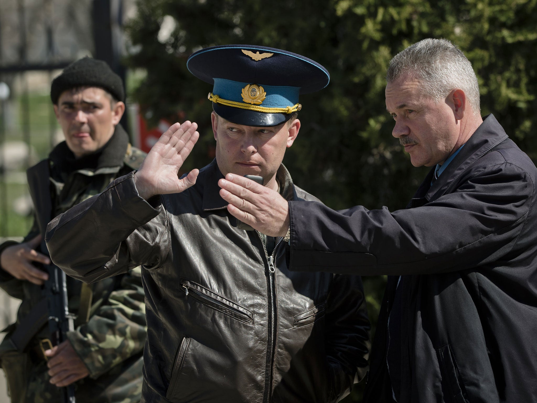 Colonel Yuli Mamchur, centre, was unwilling to hand over his air base to the Russians