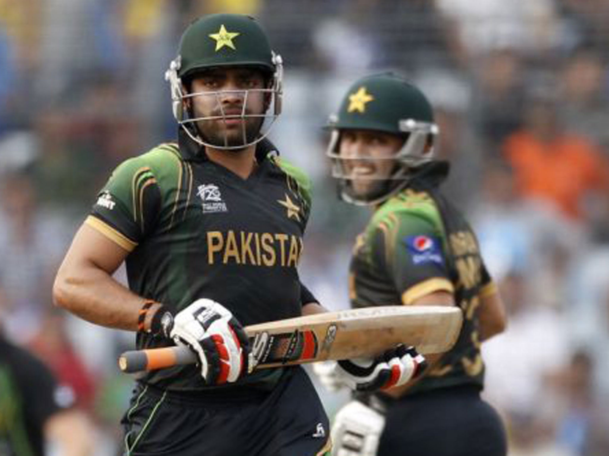 Umar Akmal (left) and Kamran Akmal on the charge in Pakistan’s 16-run victory over Australia