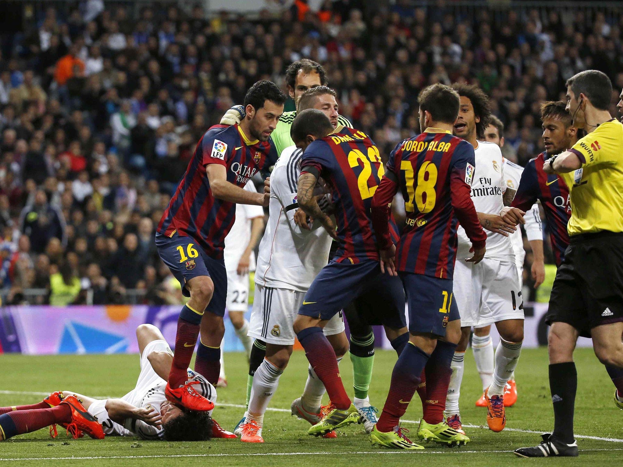 Sergio Busquets appears to tread on Pepe as Barcelona won despite Karim Benzema scoring twice