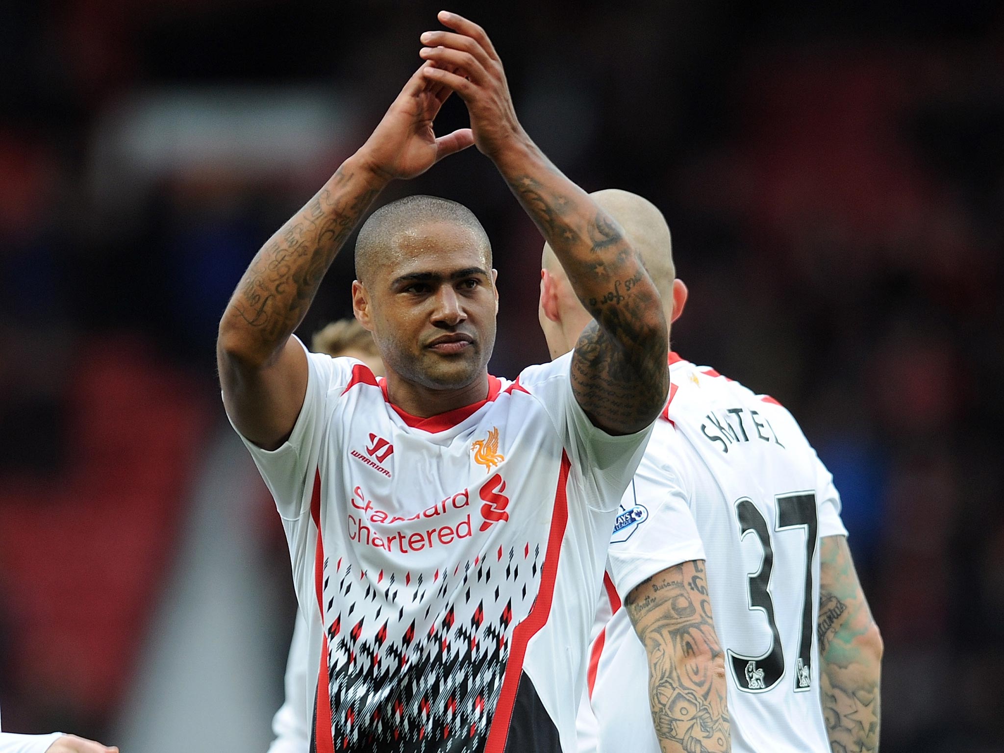 Glen Johnson applauds the travelling Liverpool fans following the 6-3 victory over Cardiff