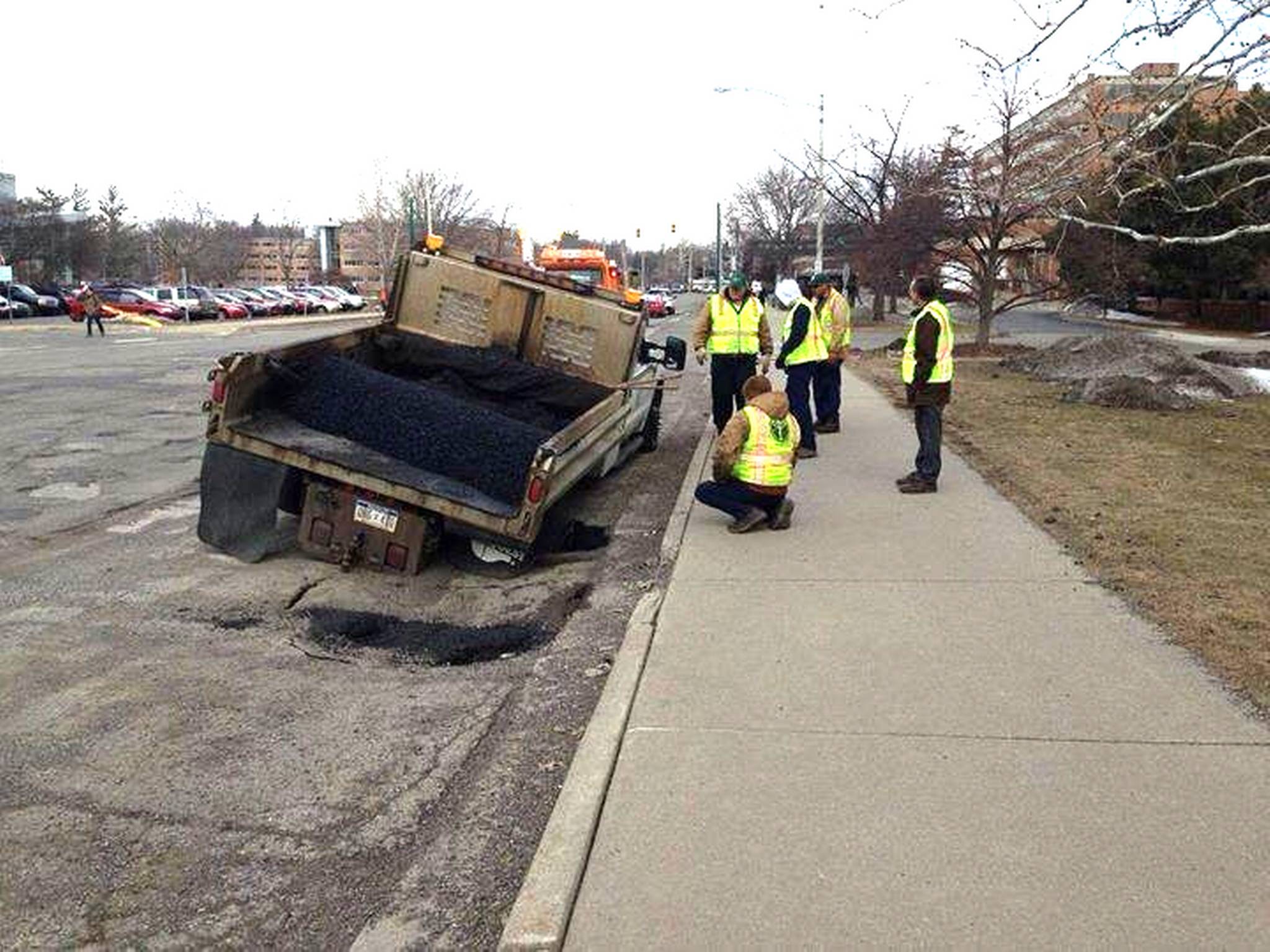 The back right tyre was swallowed up by the pothole