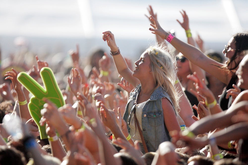 Festival fans enjoy the music in the sunshine