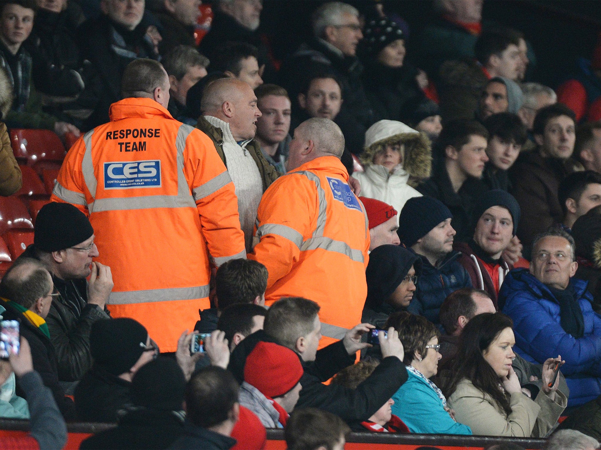 A Manchester United fan is led away by stewards after venting his frustration at David Moyes