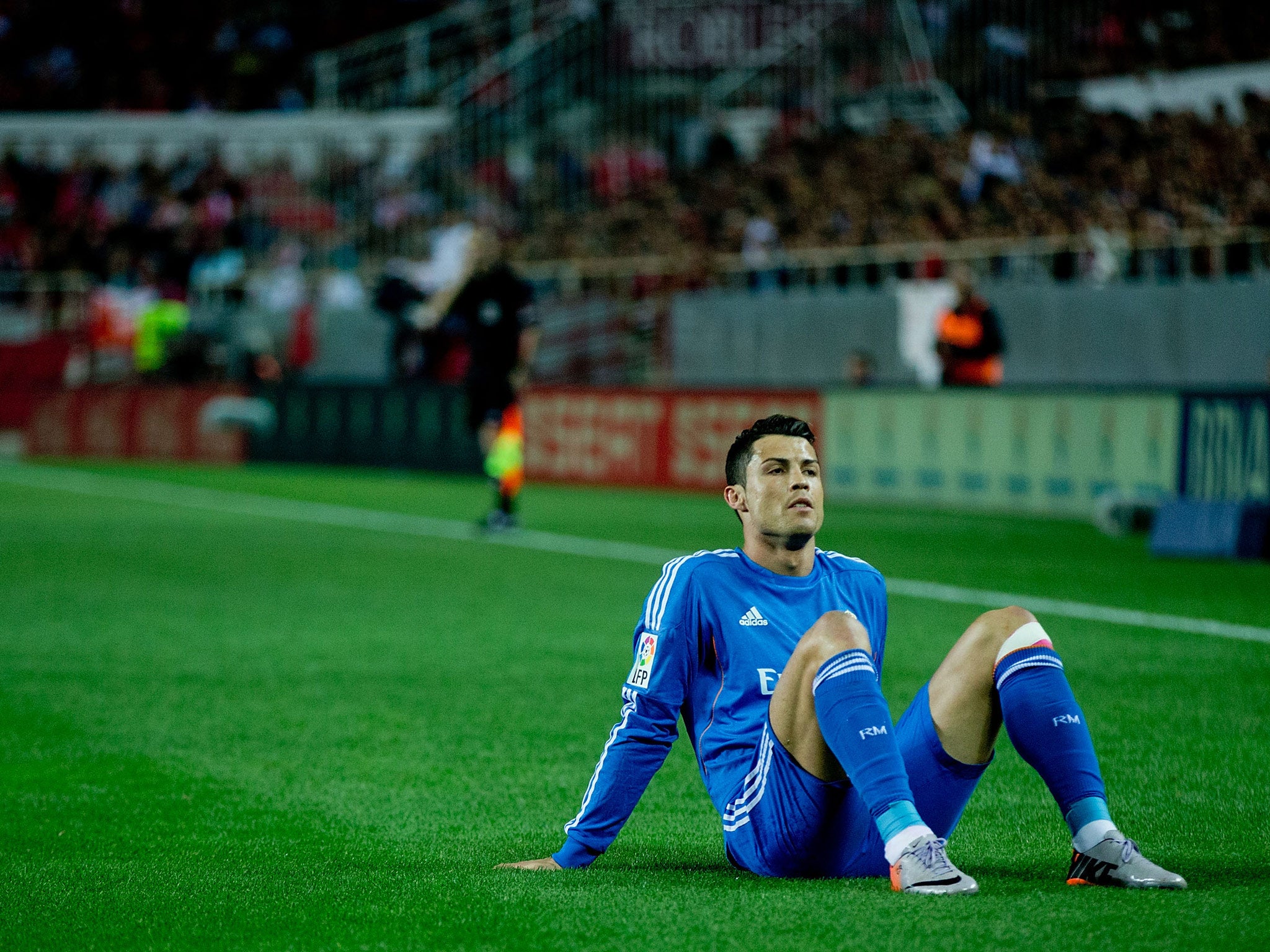 Cristiano Ronaldo of Real Madrid lies on the ground after being tackled during the La Liga defeat to Sevilla